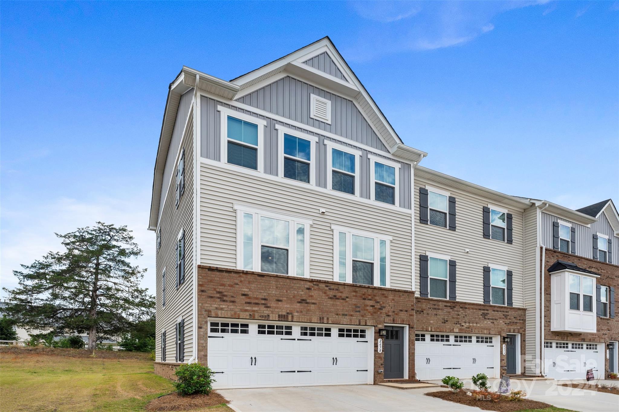 The spacious upper level features an enormous kitchen with quartz countertops, large island opening into an extensive living room with tons of natural light. On the third level you will find two spacious bedrooms with accommodating closet space and a hall bath, and a generous primary Bedroom that features a tray ceiling and a huge walk-in closet. The primary bath features a dual vanity and over-sized shower. Enjoy the convenience of a 3rd floor laundry. The main level you will enter from your two car garage into a finished recreation space. Conveniently located on the northeast side of Fort Mill you have nearby access to I-77, and just a short drive to Ballantyne and Pineville.
