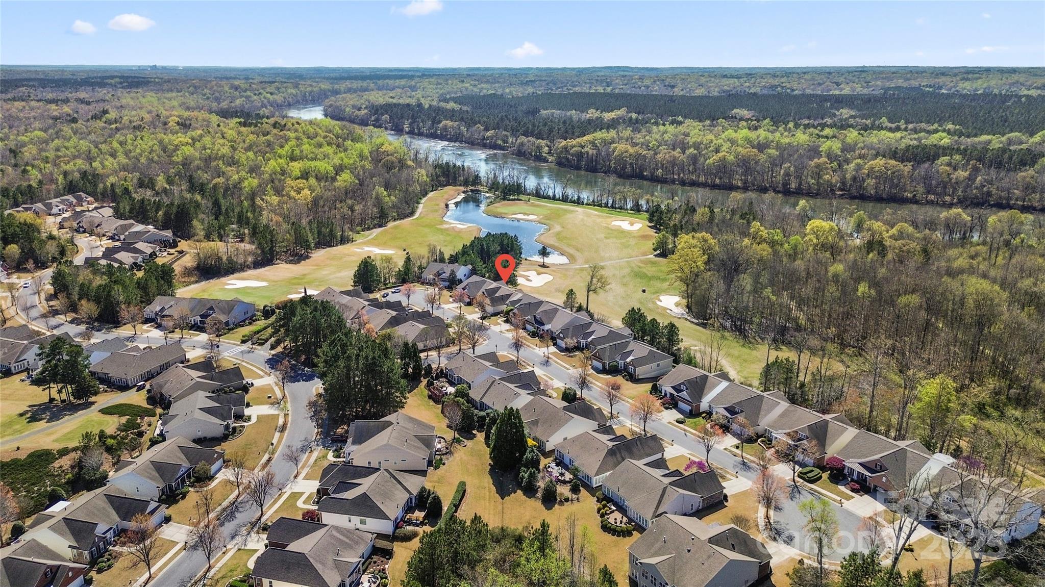 Nestled on a double cul-de-sac street, this meticulously maintained home offers breathtaking views of the Golf Course & Catawba River.  Every room, inviting and fresh, boasts neutral colors, newer LVP flooring/carpeting and light fixtures.  The kitchen w/updated appliances, center island, bar seating & custom walk in pantry opens to an eating area perfect for casual gatherings. The sunroom, offering a panoramic view, will make every morning coffee feel like a special occasion. Unwind in the primary en-suite with soaking tub, dual vanities and custom closet before you head outside to watch the sunset on the partially covered deck.  The lower level equipped with a workout room, rec room, 2 addtl bedrooms and a full bath gives you the extra space for family and guests.  The expansive outdoor patio invites you to enjoy alfresco dining and gatherings with friends, all while soaking in the stunning views.  Enjoy the lifestyle of the amenity-rich Sun City Carolina Lakes!