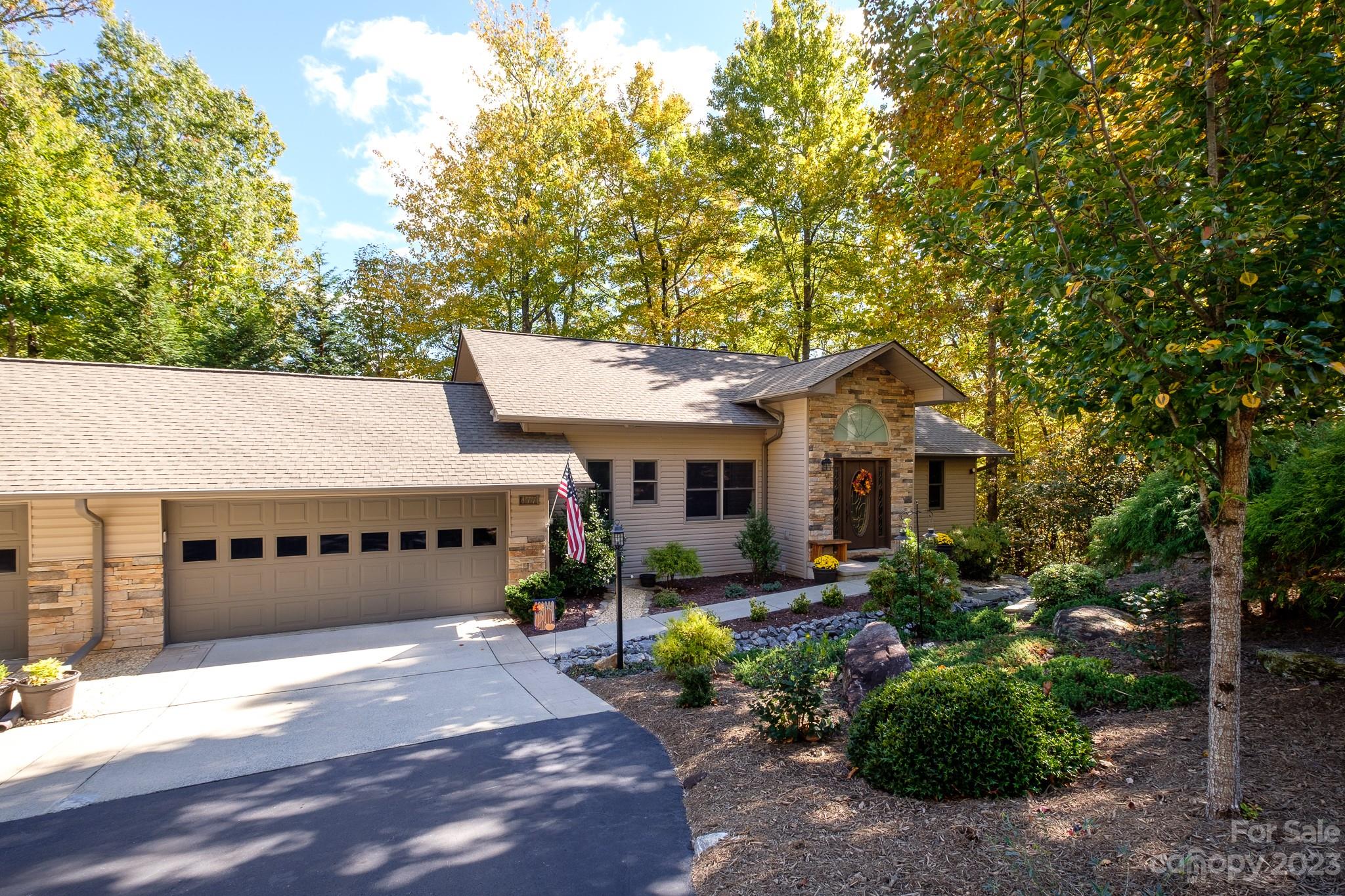 This 3 bedroom, 2.5 bath is a highly sought after, updated unit in Qualla Village. It sits nested in the trees only steps away from the flowing ponds leading to Lake Ticoa. Interior features include hardwood floors, quartz counter tops and matching appliances. The master bedroom is on the main floor and the living room features vaulted ceilings and a large stone fireplace with a new electric insert. Downstairs you will find two bedrooms and a large family room with a wet bar. The downstairs patio was recently fenced for pets. In Connestee you will find over 20 miles of pristine hiking trails, 6 waterfalls, 4 lakes totaling over 230 acres of lake frontage, an 18 hole designer golf golf course, pickle ball, tennis, pool facilities and multiple top notch food and beverage options. In addition residents of Qualla village enjoy private lake access with 2 boat docks, community water craft, and the association provides scheduled maintenance services for decks driveways and home exteriors.