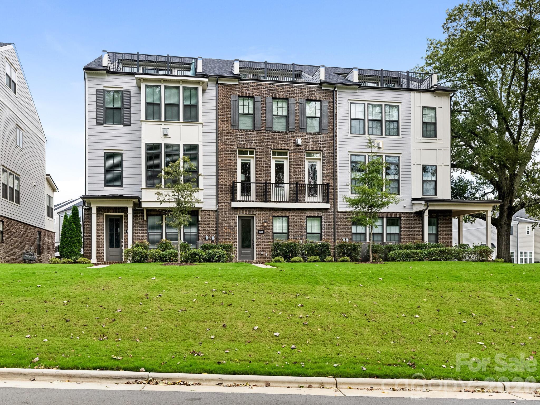 Fabulous townhome located in the sought after Elizabeth neighborhood, surrounded by trees and sidewalks. Enter the lower level from your attached two car garage to a generous mudroom/drop zone, plenty of storage and ensuite bedroom. Walk up the stairs or ride your ELEVATOR (services all four levels) to the main level featuring open concept living, high ceilings and hardwood floors. Kitchen features a built in JennAir refrigerator, KitchenAid 6 burner gas range with pot filler, ample cabinetry, built in microwave and oversized island with seating for five. The light filled family room looks toward a canopy of mature trees and offers an exposed brick fireplace. Formal and informal dining areas and a cozy sitting area which opens to a balcony. On the Upper Level, the primary bedroom has wood beams along the ceiling, a beautiful dual vanity ensuite with soaking tub and walk in shower, huge closet. Second ensuite on this level, as well as the laundry room, complete with a sink. The third floor could be a 4th bedroom or is perfect for a home office. Private rooftop terrace with turf which overlooks a park like setting. Enjoy the convenience of the Sonos and Eero wi-fi systems, in addition to the other smarthome features such as Nest thermostats and front and garage door systems. This is a great opportunity to be in the heart of town.