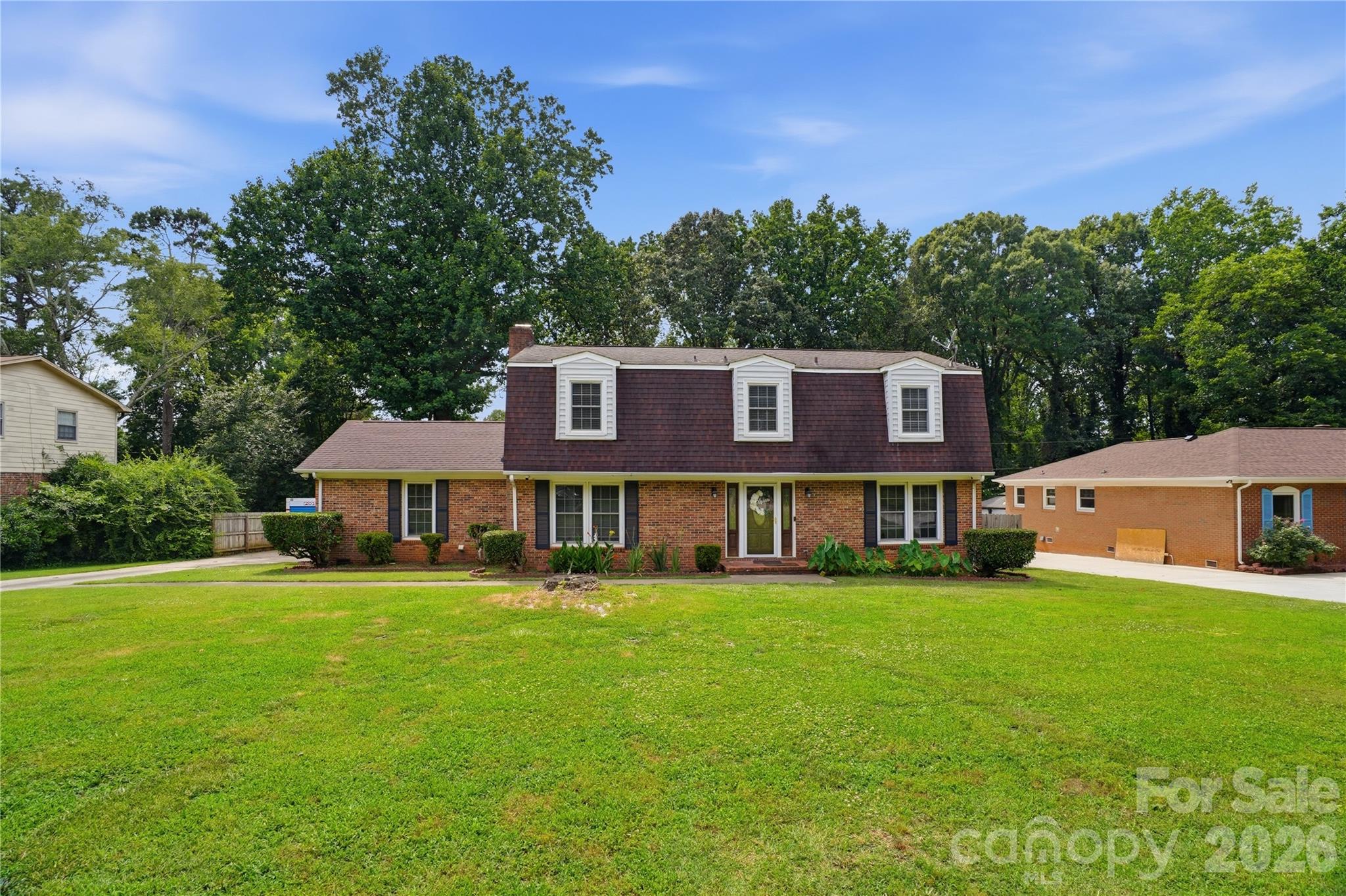 Lovely 4 Bedroom 2.5 Bath Home nesteld in the established neighborhood of Ravenwood.  This home sets on approximatley a 1/2 acre lot in the city of Charlotte.  Featuring an excellent floor plan with large living areas on the main level and an updated Kitchen (corian countertops, peninsula island, tile backsplash, recessessed lights, double oven, microwave, refrigerator, built in cabintry, 2 pantries and tile flooring)  that leads to a large screen porch overlooking  a mature fenced backyard. In addition, the lower level features a formal Living Room, Formal Dining Room, Family Room with fireplace, Breakfast Area, Recreation/Bonus Room with wet bar; and Powder Room.  Laundry hookup is in a closet in the Bonus/Recreation Room. Upstairs include large bedrooms  - wood flooring and ceiling fans in all rooms.  See the  attached oversized two-car carport with huge shop/workspace included -  providing exceptional storage and workspace potential. Home is being sold as-is and offers tremendous potential for  Buyers or  renovators looking to add their personal touch.  Priced to Sell!!! No HOA's with this home.