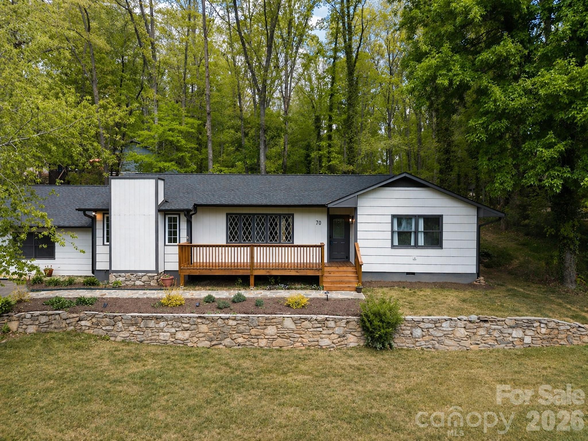 Beautifully updated, move-in ready main-level home in desirable Candler. This 4-bedroom, 3-bath property features a newly painted exterior, updated roof, gutters, chimney, porches, new flooring throughout, and fresh interior paint. Pre-inspected and ready for its new owner. Flexible floor plan includes a separate living area with private entrance, bedroom, full bath, laundry, and kitchen—ideal for an in-law suite or investment opportunity. Detached carport with enclosed workshop and storage adds extra functionality. Enjoy updated landscaping with new drainage systems and a newly built back deck, perfect for entertaining. A versatile property offering comfort, convenience, and opportunity.