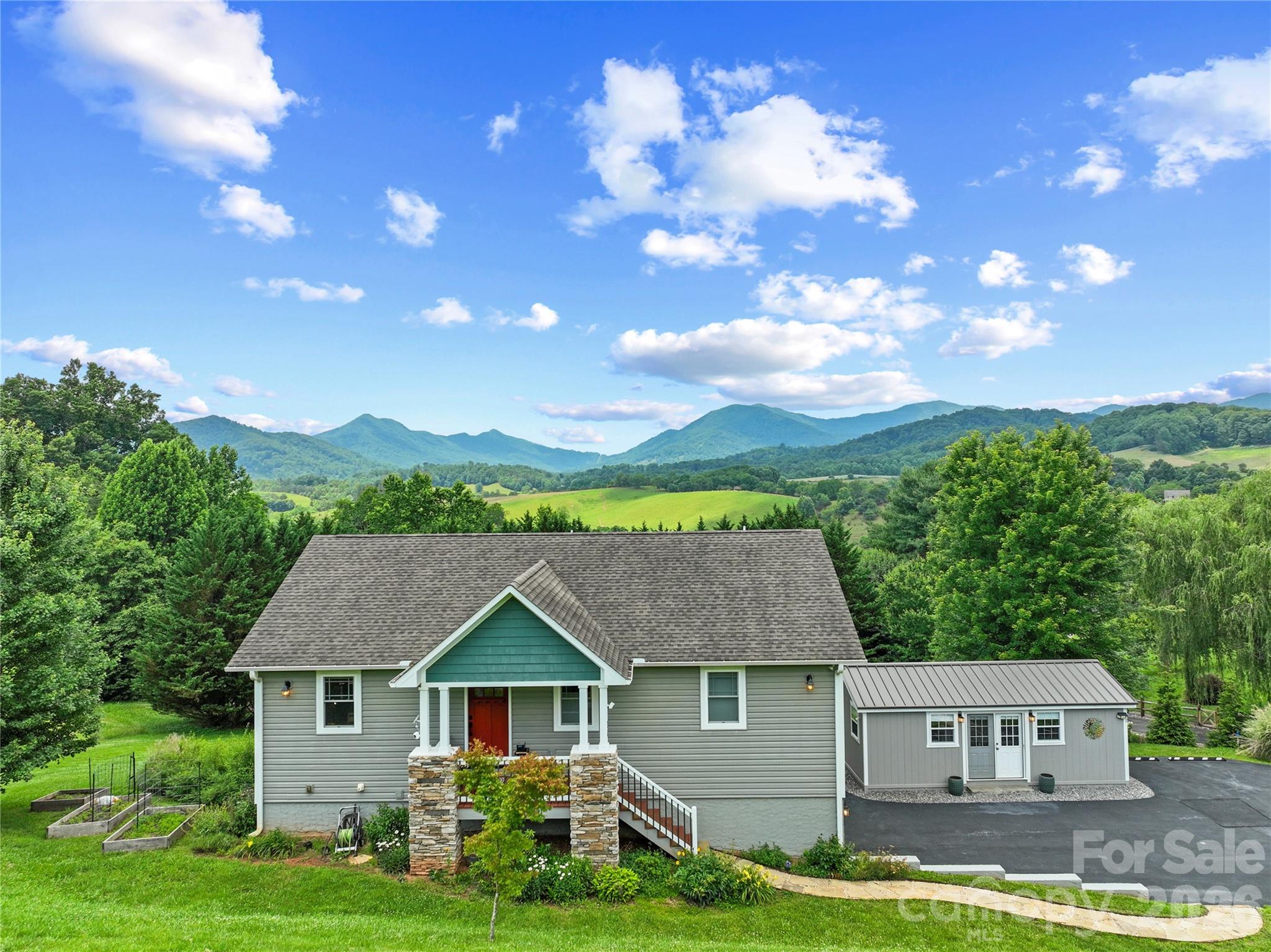 This home embodies a sense of tranquility born from curated design, quality craftsmanship, and breathtaking long-range mountain views. Meticulously maintained by its current owners, this three-bedroom, two-and-a-half-bath residence has been enhanced with high-quality improvements throughout, including beautifully updated kitchen and baths.  At the heart of the home is a sophisticated kitchen featuring Bosch black stainless steel appliances, solid cherry cabinetry, granite countertops, and custom storage. The main level is filled with natural light and elevated by vaulted ceilings that create an open atmosphere throughout the living area.  Designed for comfortable main-level living, the home offers a spacious primary suite and dedicated office, while the lower level provides two additional bedrooms, a recently remodeled full bath, and a versatile flex space ideal for a gym or additional storage.  Accessed from downstairs, the two-car garage with storage was recently professionally updated with polyaspartic flooring and an industrial sink with a wall mounted faucet and sprayer.  Further enhancing the property is a detached studio, completed in 2023 by skilled trades professionals. This heated and cooled space features a metal roof, hardwood flooring, French doors, and inspiring views of Hanlon Mountain, making it well suited for a variety of uses.  Outside, the generous one-acre lot offers three raised garden beds and an variety of established perennial flowers, creating a beautiful and ever-changing landscape. Thoughtfully tucked beneath the rear deck, a custom storage shed with electricity adds convenience and functionality to the property.   A comprehensive overview of the property's features, improvements, and plantings is available upon request. Please ask your Realtor for additional information.
