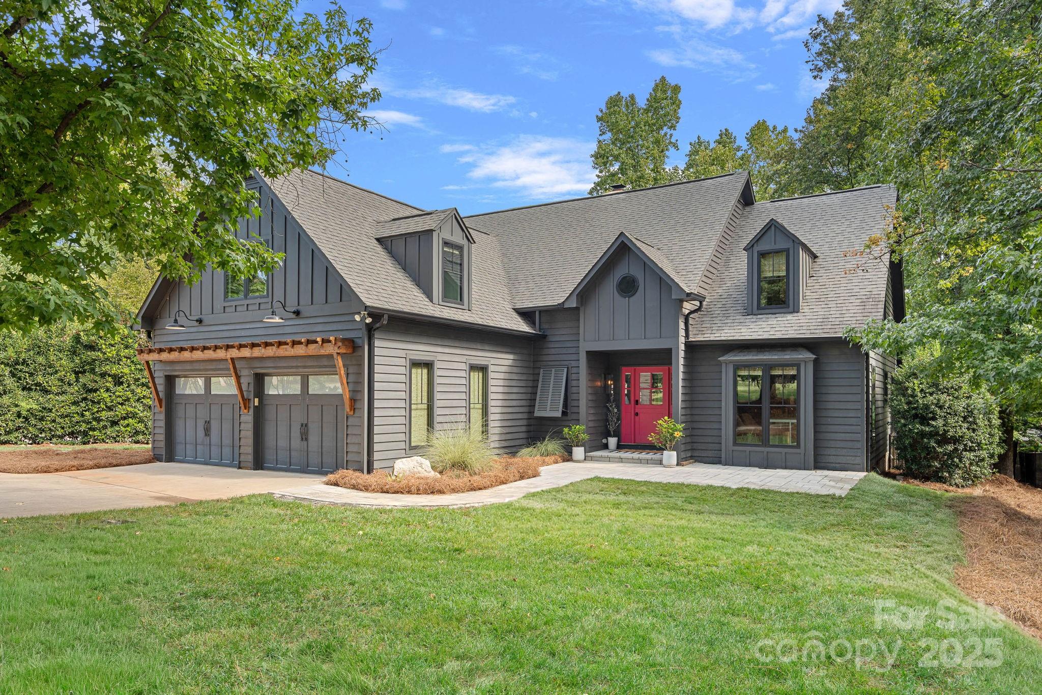Featured in QC Magazine and showcased on houzz.com, this Lake Norman home was professionally designed by Collaborative Interiors and seamlessly blends modern elegance with relaxed lakeside living. Originally built by Simonini Homes and thoughtfully updated by APS Renovations, every detail has been elevated to reflect timeless sophistication. 
Step through the Dutch-style front door into a sunlit interior with a clean, inviting color palette and earthy hardwood floors throughout most of the home. The two-story great room features a reclaimed wood mantel, stone gas-log fireplace, custom built-ins, wine fridge, ice maker, hidden work station and file drawers, perfect for blending work and leisure.
The main floor primary suite allows for one floor living, the second floor features three bedrooms with a large bonus, don't miss the great storage closet! The open kitchen is a showpiece of form and function, framed by floor-to-ceiling windows and outfitted with luxury stainless steel appliances, quartz countertops, and a large island ideal for entertaining. New roof being installed on 10/13!!
Enjoy seamless indoor-outdoor living with a raised porch featuring retractable screens, its own kitchen and dining area, and direct access to the sundeck and sunroom. A stunning fireplace and four infrared ceiling heat lamps create a year-round retreat for entertaining or relaxing.
Set on 0.62 acres with a covered dock, boat lift, and seating area, the property offers direct lake access and a private slice of waterfront serenity. All windows and doors have been replaced, bathrooms updated, and custom lighting installed throughout.
An oversized two-car garage with epoxied floors, built-in shelving, and a dedicated workshop adds practicality to the polished aesthetic. Located just a short walk from The Peninsula Club and Jetton Park, this home offers not only luxury, but lifestyle.