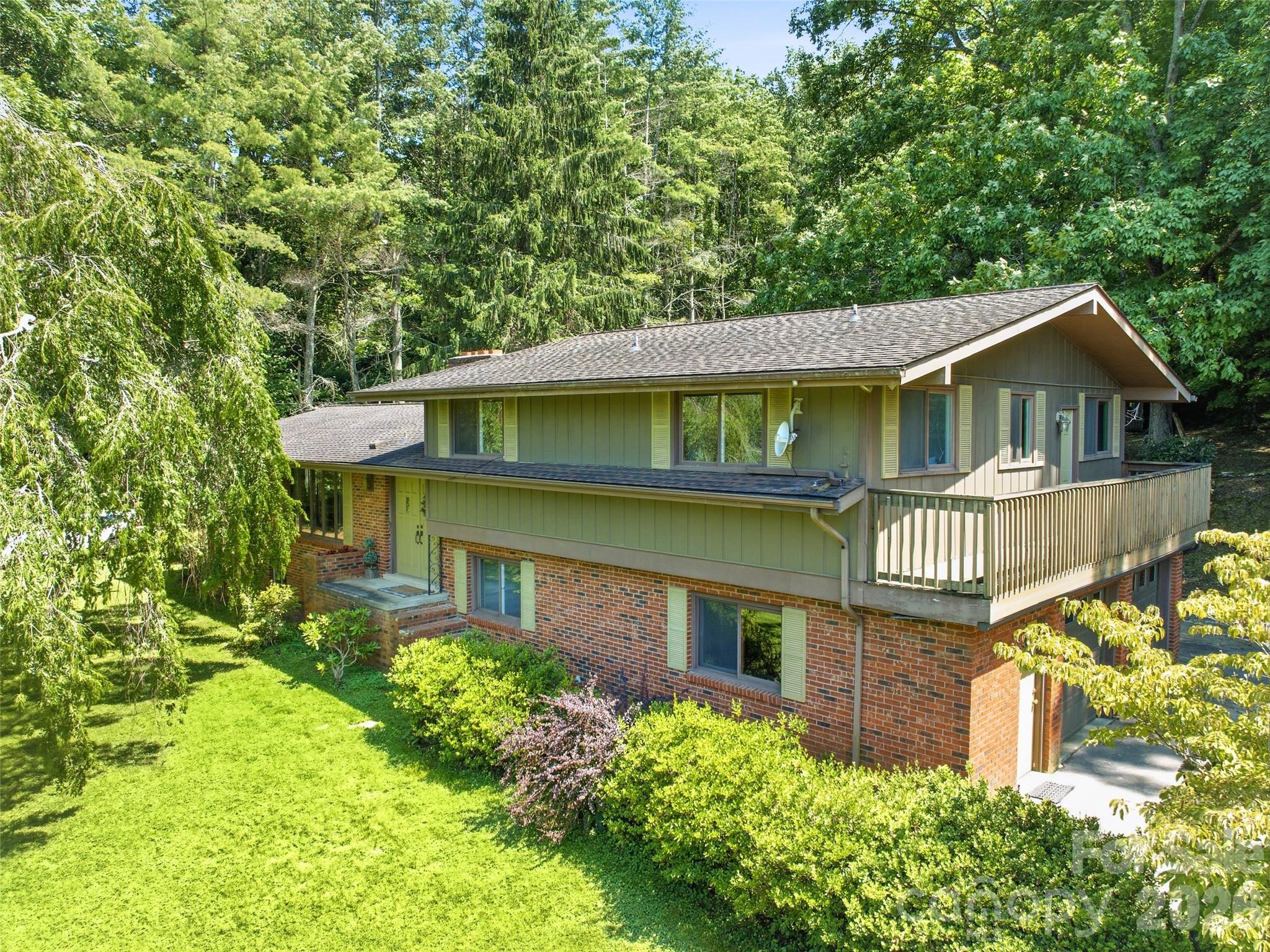 Tucked away on 11.1 acres of peaceful countryside, this 1973 split-level brick home offers the rare combination of privacy, usable land, and close proximity to town. Located just 5 minutes from local amenities, yet set in a quiet, private setting where the only sounds you'll hear are those of nature, this property provides the best of both worlds. With no HOA and no restrictions, you'll have the freedom to truly make this property your own.

The home features a wrap-around driveway, attached two-car garage, and easy year-round access. The unrestricted property is a beautiful mix of open and wooded land, with expansive, usable yard space that's ideal for gardening, outdoor entertaining, recreational activities, or simply enjoying the mountain lifestyle. Mature trees and landscaping, established flower beds, and a variety of fruit trees create a park-like setting that's been lovingly cared for over the years. Behind the home, trails wind through the woods, inviting you to explore your own private retreat, while several outbuildings and sheds provide excellent storage for tools, equipment, hobbies, or outdoor gear.

Inside, you'll find an incredible amount of living space with a flexible floor plan. In addition to the three-bedroom septic system, the home offers a spacious bonus room, dedicated office, convenient half bath off the garage, and a finished basement featuring a large family room with a cozy fireplace and kitchenette. Whether you're looking for room to spread out, work from home, entertain, accommodate guests, or enjoy multi-generational living, this home offers exceptional flexibility for a variety of lifestyles.

Lovingly maintained over the years, the home offers solid construction, quality craftsmanship, and great bones. While many of the finishes reflect its original era, it presents an excellent opportunity to update at your own pace and create a home that reflects your personal style without starting from scratch.

Whether you're dreaming of a mini-farm, a private mountain retreat, or simply owning a beautiful piece of unrestricted land just minutes from town, this unique property offers endless possibilities and is ready for its next chapter.