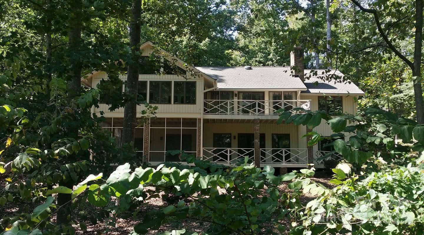 Large home with primary on the main and rest of bedrooms downstairs and an amazing kitchen renovation! 10x12 center island to work on and gather the family!!  So much natural light in this home!  Sun porch was incorporated into the living space with floor to veiling windows and skylights.  Huge room between garage and kitchen that can be flex space/office/kid drop zone/ storage .  2nd scullery auxiliary kitchen of the main kitchen so room for everyone!! Enjoy the golfers and lake views.  Large screened in porch downstairs and expansive decking on both levels to enjoy outdoor living.  There is another room than can be finished for yet another bedroom or flex space if needed.  Come see this 1!