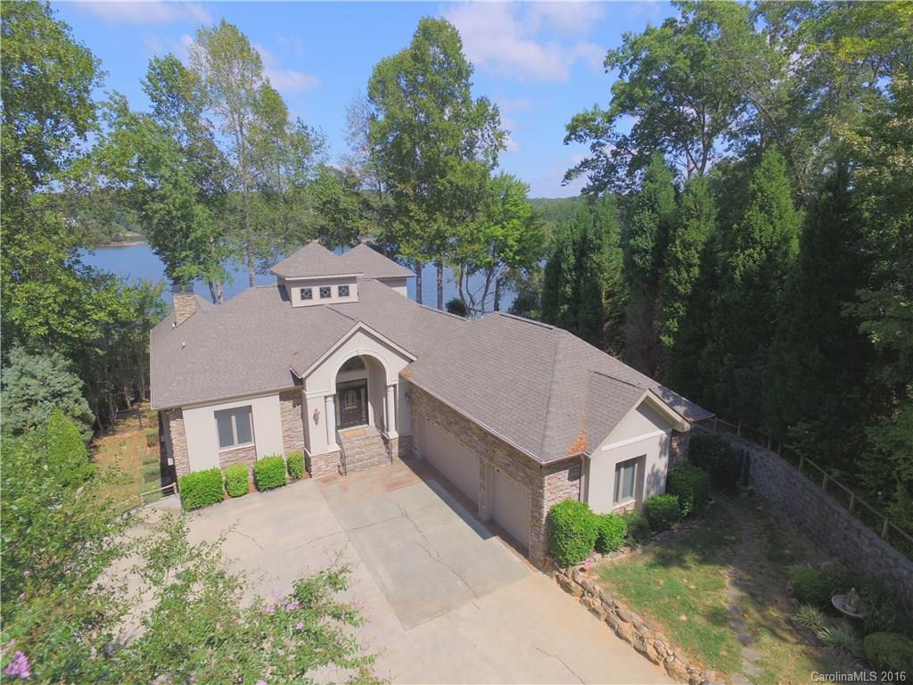 Motivated seller! One of a kind Custom built WF Home on 1.32 Acre point lot on the main channel with over 500 ft of shoreline & a park like feel! Gated community with 46 waterfront lots. Home has 4 bedrooms with 4.5  baths. 3 story elevator. This home has 2 decks off the back with a large covered lower patio. 3 car garage. Don't be left in the dark this home has a Generac generator. Your boat dock is off the main channel and close to a marina. Only 50 min to CLT airport.