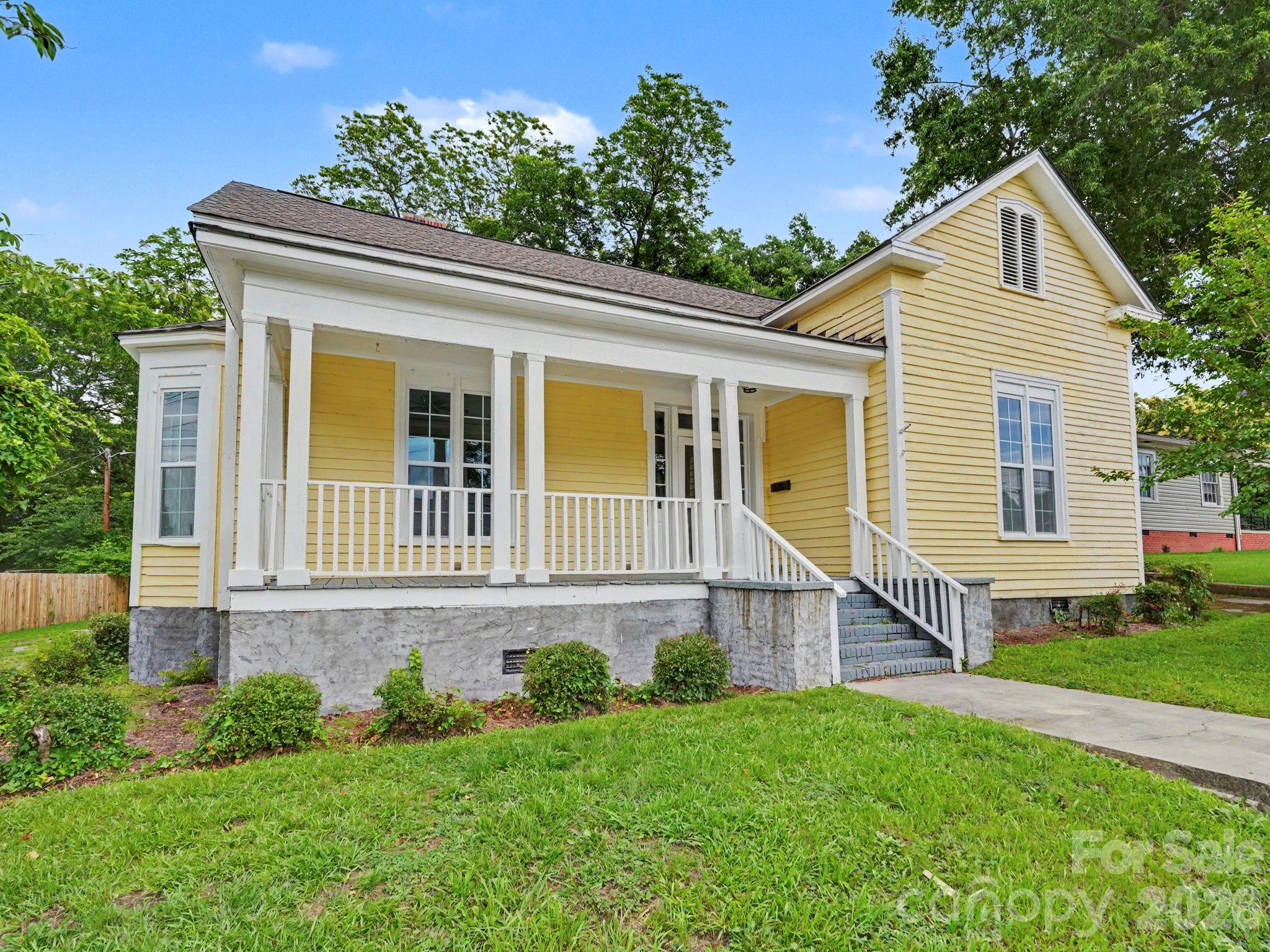 Welcome home to this beautifully maintained 3-bedroom, 2.5 bath residence offering 1916 sq. feet of inviting living space in the heart of Lancaster, SC. Combining timeless charm with modern conveniences, this home is filled with character and designed for comfortable everyday living.

Step onto the welcoming rocking chair front porch,the perfect place to relax and enjoy your morning coffee or unwind at the end of the day. Inside, you'll be greeted by high ceilings,beautiful hardwood floors, abundant natural light,beautiful hardwood flooring and spacious rooms that create an open and airy atmosphere throughout the home.

The well appointed kitchen features ample cabinet space, appliances and plenty of room for meal preparation and entertaining. Just off the kitchen is a versatile bonus room that can easily serve as a family room, home office, playroom, dining area or hobby space to fit your lifestyle needs.
