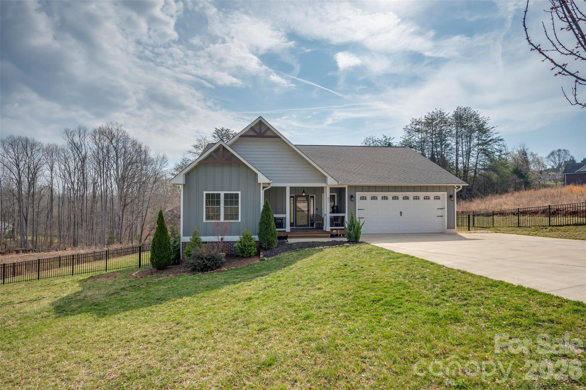 Charming Arts & Craft home in the heart of the WNC foothills just minutes from downtown Rutherfordton.  Eye-catching curb appeal w/attractive mix of board & batten, shake, & lap siding accented by rich wood gable brackets.  Generous .73acre lot, fenced yard, new matching storage building & fully encapsulated tall crawlspace.  Cross the threshold and discover an everyday elegance that's the perfect balance of upscale finishes with superb functionality.  From the foyer, turn left to guest bedrooms & shared bath or turn right to a cozy cubby/drop zone space leading to the garage.  As you head down the hallway, the laundry is on the right - conveniently located in the middle of the house & away from the primary while near the kitchen.  And talk about the kitchen...impeccably designed cabinetry, huge bar/island, quartz counters w/glass tile backsplash, and chimney style wall hood as the focal point.  Terrific open layout for entertaining or gathering family w/dining area, spacious great room & french doors out to the covered porch/deck area.  Entrance to the primary bedroom is tucked just off the great room for a nice sense of separation.  Wonderful ensuite bath w/freestanding tub, dual sink vanity, tile shower & incredible walk-in closet.  DON'T MISS this tremendous opportunity to own such a well-designed & executed 2022 build that's minutes from Rutherford Regional Hospital, close to US Hwy 74, and less than 30 minutes from I-40 & I-26.  Perfect balance between the convenience of being near town with public water and yet unrestricted with no county zoning and no monthly HOA dues.