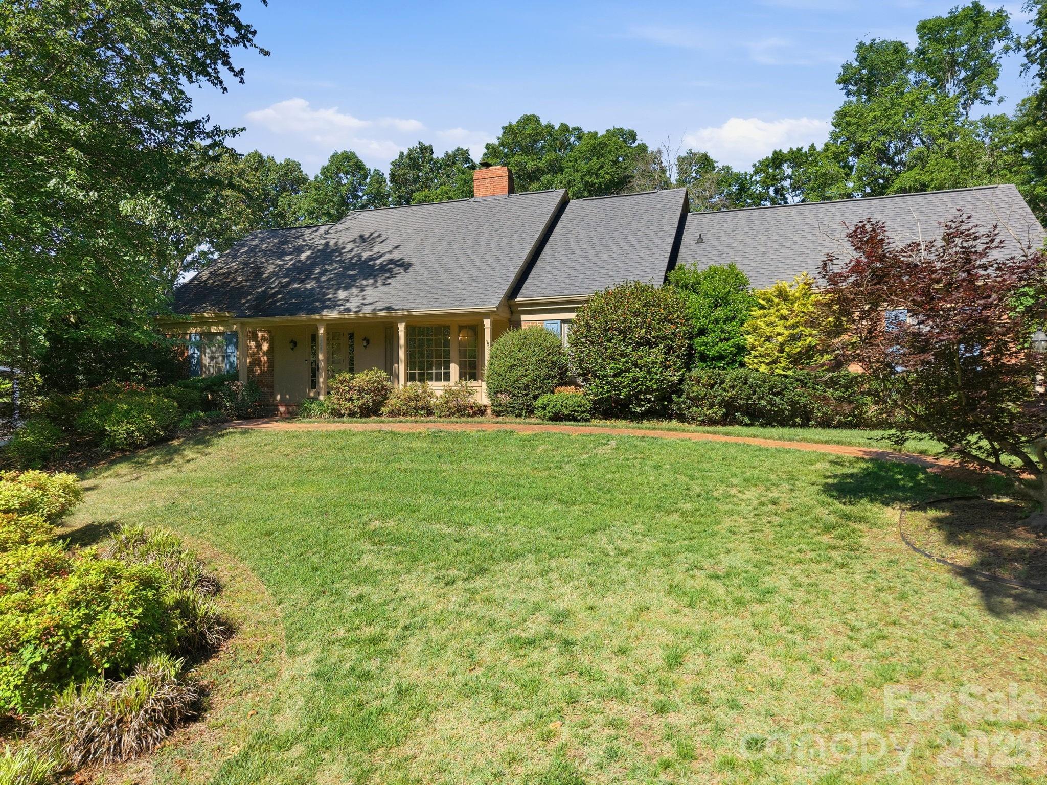 This checks all the boxes! Located in the desirable Country Club of Salisbury, this home welcomes you with exposed beams. The dining area has a beautiful bay that looks out to the lush front yard. Through the kitchen and breakfast area is a huge multi-purpose room that also has exposed beams. It is currently a home gym, but the possibilities in this space are many. The primary bedroom is on the main level. The other bedrooms are on the second level, where there is walk-in access to lots of attic storage. This is also where you'll find the tankless on demand hot water heater. Back downstairs, the living room leads to a fantastic screened in porch that carries you out to the heated swimming pool and fenced in back yard. There is an irrigation system. The garage has a pool pump and storage room at the back. This house even has a charger for your electric vehicle. All this with no HOA! Membership to the country club is optional, but the Donald Ross course is a golfer's delight. There are also tennis courts, swimming and the clubhouse here. The only thing this house is missing is you and your personal touch!