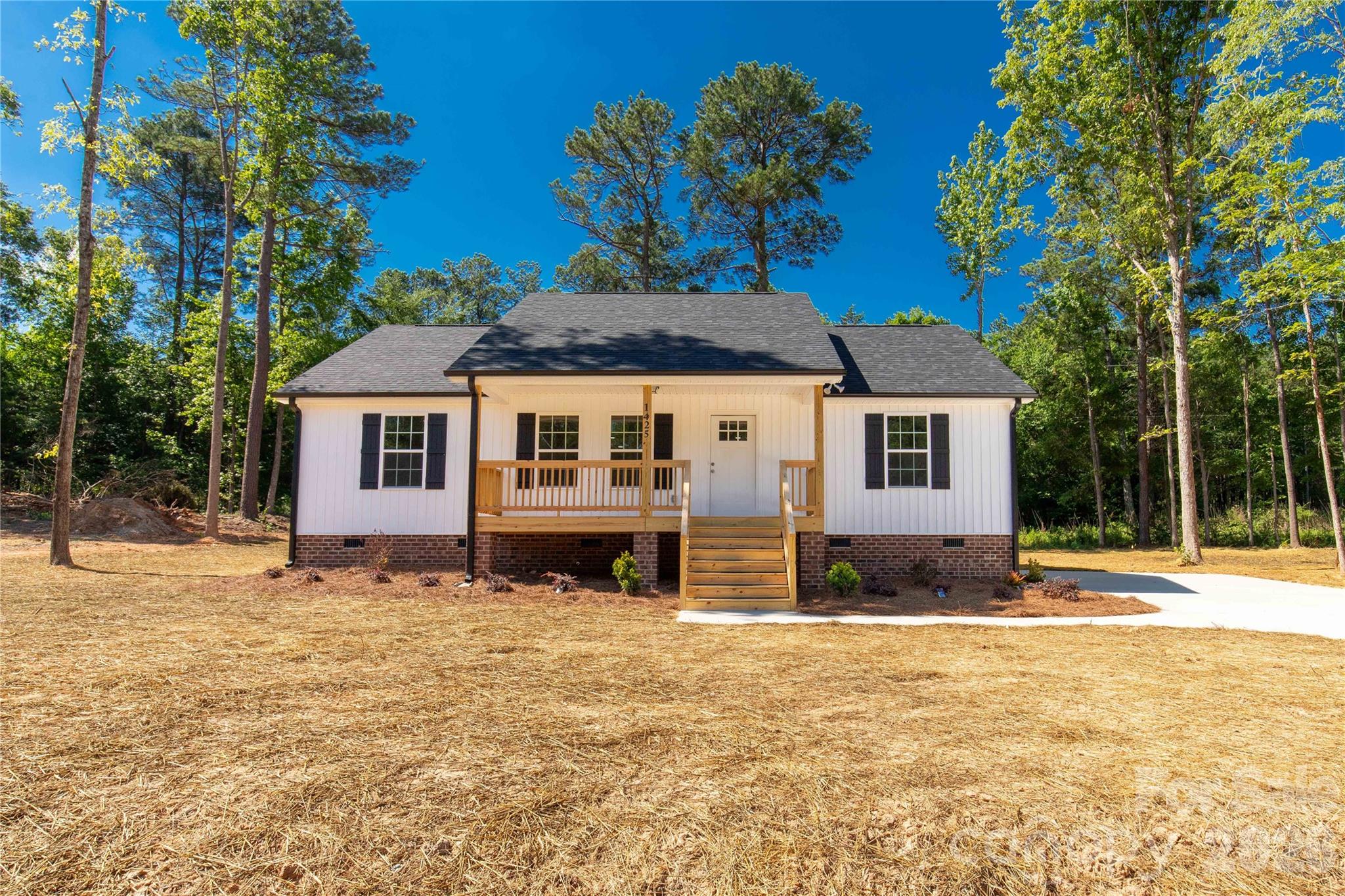 Brand-new construction offering the perfect blend of modern comfort and timeless Southern charm. A welcoming rocking-chair front porch sets the tone as you arrive, framed by a peaceful country setting that feels like home from the start.

Inside, you’ll find a light, neutral color palette with soft gray and warm beige tones that complement any style. The open-concept main living area connects seamlessly to a well-appointed kitchen featuring a large center island, granite countertops, stainless steel appliances, and ample workspace for everyday living and entertaining.

The thoughtfully designed split-bedroom floor plan provides privacy, with the primary suite positioned separately from the secondary bedrooms. The private owner’s retreat includes a comfortable layout and an en-suite bath designed for relaxation.

Step outside to the covered rear porch, ideal for morning coffee or winding down in the evenings while enjoying the surrounding outdoor space.

Move-in ready and built with care, this home delivers comfort, function, and style in a serene setting. Schedule your private showing today.