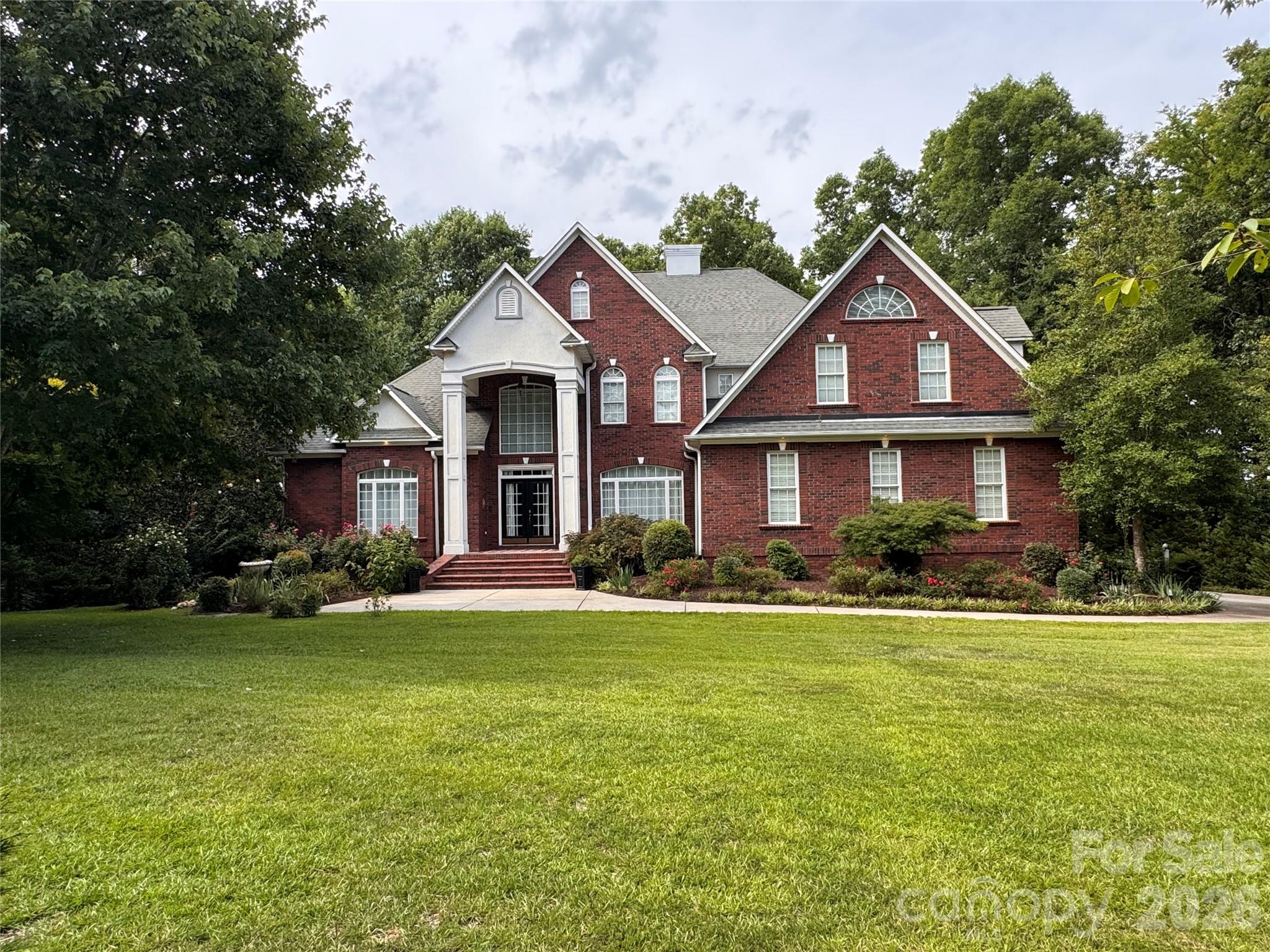 Extraordinary All-Brick Custom Estate on Over 2 Private Acres!  Prepare to fall in love. This stunningly beautiful all brick custom built home offers over 4,200 square feet of thoughtfully designed living space on more than two picturesque acres, backing to a peaceful creek with unobstructed views of rolling acreage as far as the eye can see. Rarely does a property combine this level of craftsmanship, space, and privacy in one setting.
Step inside to find gleaming hardwood floors, soaring high ceilings, and elegant French doors that frame the natural light throughout. Custom details are woven into every corner of this home, creating a sense of warmth and sophistication rarely found in today's market. The kitchen is truly a chef's delight, boasting an abundance of counter space perfect for cooking and entertaining, all flowing seamlessly into an open concept family room that keeps everyone connected, whether you're hosting a crowd or enjoying a quiet night in.  Retreat to the spacious primary suite, featuring a spa-like ensuite bath and an impressively sized walk-in closet built for the most discerning wardrobe. Upstairs, three additional generously sized secondary bedrooms share a full bathroom, along with a versatile bonus room currently used as a home office ideal for remote work, a playroom, or a media space.  Outdoor living reaches an entirely new level here. Step out back to a wonderful covered patio, the perfect spot to unwind and take in the scenery. Follow the steps down to an enclosed patio leading to a covered outdoor kitchen and grill area, complete with a U-shaped countertop offering plenty of seating for guests. Continue through the gate and down the pathway to discover a detached screened-in porch with an extended deck, ideal for entertaining larger gatherings under the stars.  Car and hobby enthusiasts will be thrilled with the sheer amount of storage and garage space this property offers: a 2-car attached garage, a 2-car detached garage beside the driveway, a 3-bay garage behind the home with bonus room above, and a dedicated RV garage. Whether you have an extensive vehicle collection, boats, equipment, or simply need room to grow, you'll never run out of space here.  Additional peace of mind comes standard with a whole-home backup generator, ensuring comfort and convenience no matter what.  This one-of-a-kind estate is a rare offering schedule your private showing today.