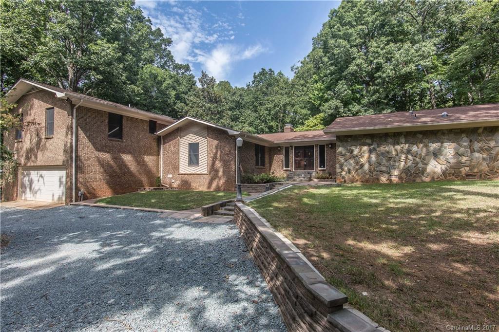 Sprawling Marvin home on over 1.3 acres in quiet neighborhood w/NO HOA!! 5 bedrooms w/2 flexible bonus rooms ideal for craft/game room or office space. Open floor plan features huge kitchen w/custom island, breakfast bar, granite counters & stainless refrigerator & microwave. Large family room w/cozy wood burning fireplace, elegant dining room & beautiful enclosed sun room overlooks the relaxing pool! Enjoy the outdoors on the large deck overlooking peaceful backyard surrounding mature trees.