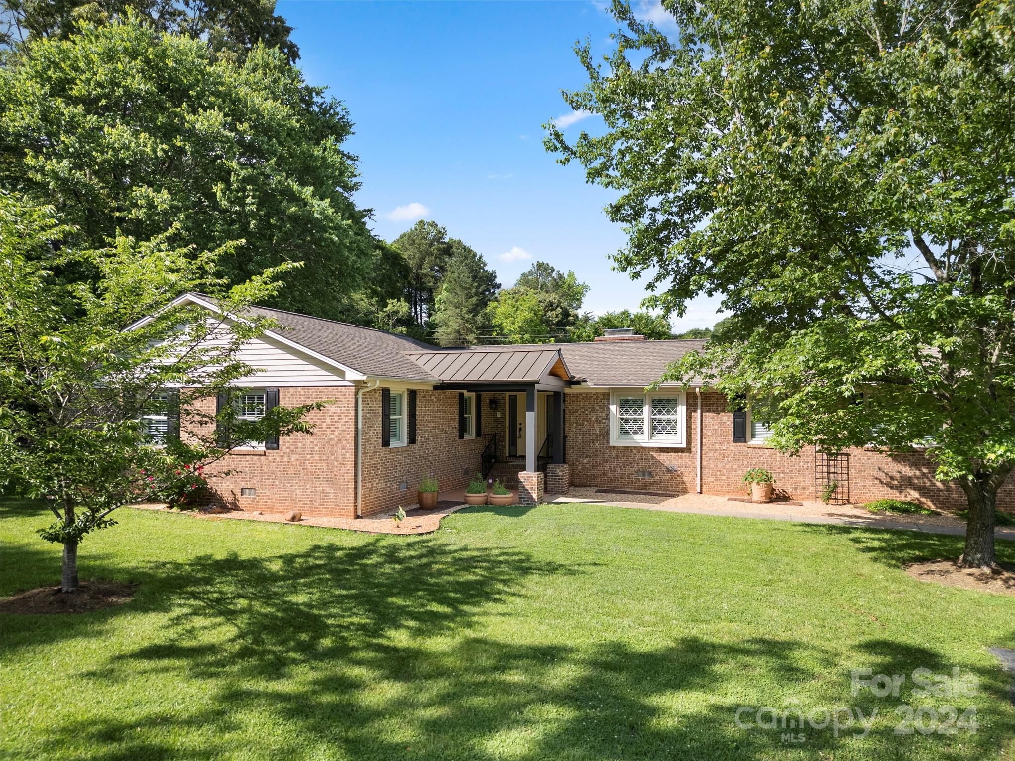 Discover this all brick, beautifully maintained 3-bedroom, 2-bathroom house located in a pristine country setting in Clover, SC. Nestled on a spacious property comprising two parcels, this home offers a generous 2,200 sq ft of living space designed for relaxation and easy living.  The highlight of this property is undoubtedly its expansive outdoor space combined at 4.77 Acres. The large lot provides ample privacy, making it an ideal setting for those who cherish their peace and quiet as 2.93 acres remains wooded. The outdoor area features a delightful gazebo and a massive workshop equipped with water and power—perfect for hobbies or a home-based business. Additionally, there's a useful shed for extra storage. Residents will appreciate the absence of an HOA, offering more freedom and flexibility with fewer restrictions. The property also benefits from being in the sought-after Clover school district, known for its commitment to excellence in education. Parcels have two map id #'s.