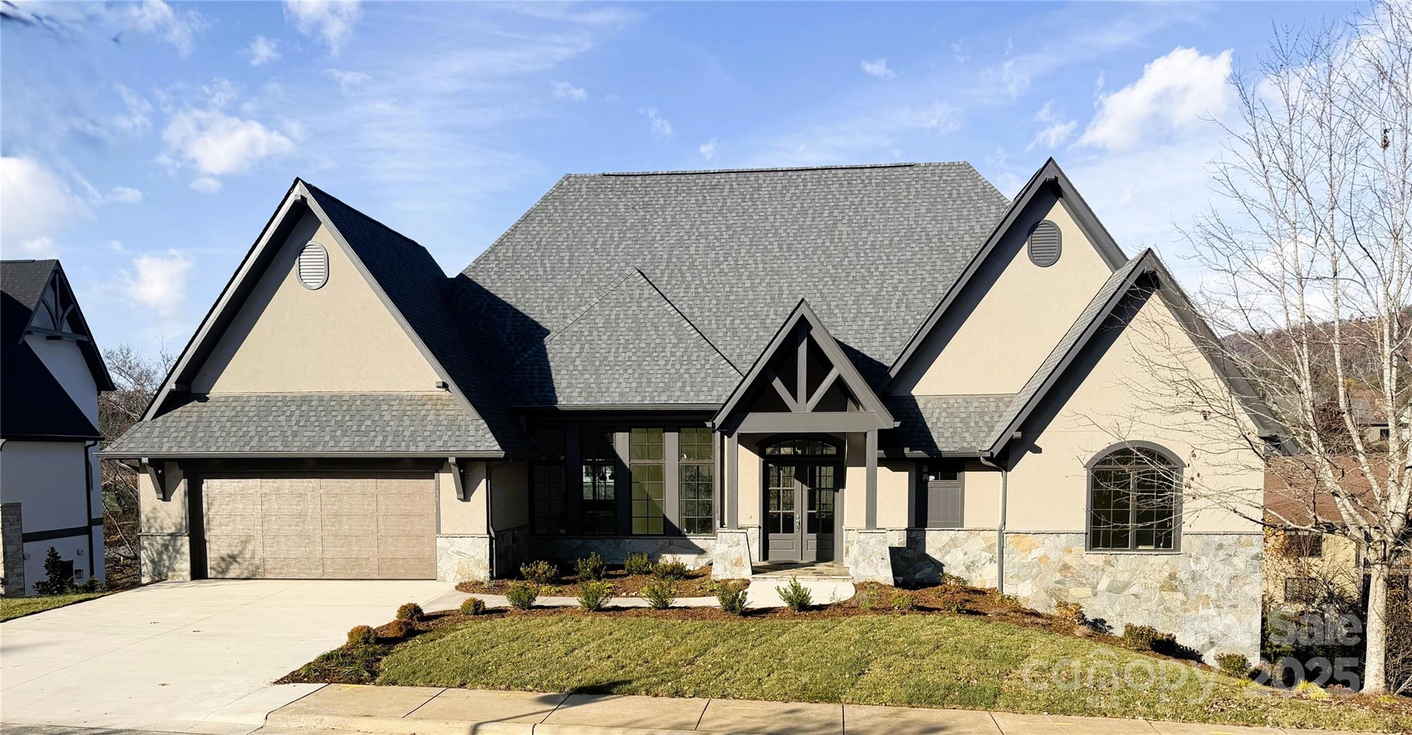 Newest home from the developer at The Thom's Estate!  NEW CONSTRUCTION!  Completion Date:  11/17/2025

More Photos Coming Soon.

This European inspired custom home plan features main level living with custom finishes.  Near the end of a large cul-de-sac, this home offers an open concept with the kitchen and great room opening onto a screened porch.   The great room and porches look out towards the mountains through large windows offering ample light.  Energy Star Certified (in process), the home features improved insulation, enhanced heating and cooling and Energy Star appliances including an induction range.  The lower level features a recreation room with built in beverage bar with sink, powder room, a second ensuite and two additional guest rooms.