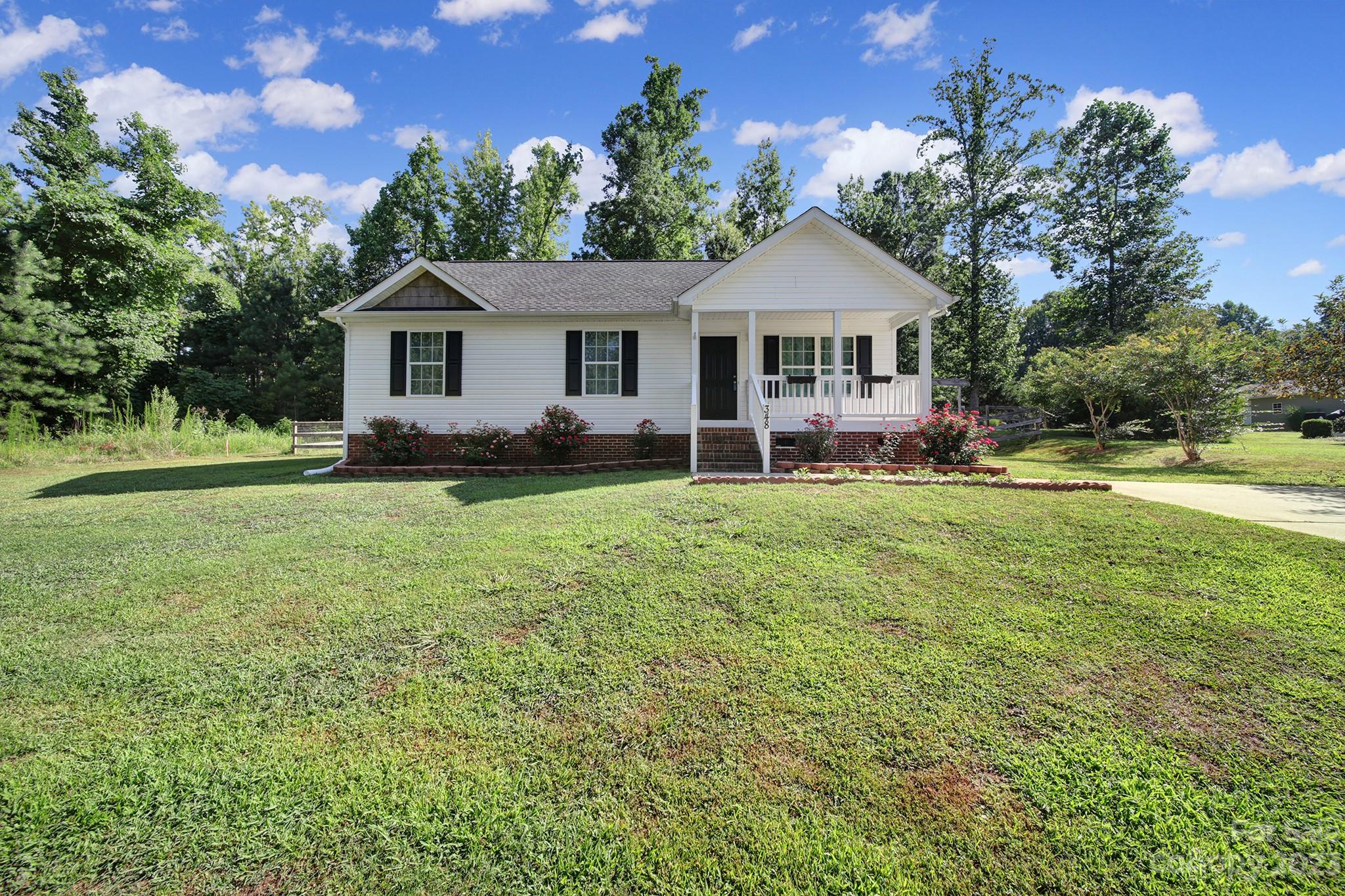 Check out this adorable 3 bedroom 2 bath home with no HOA on 1.94 acres! There is CCR's and they are minimal. Beautiful lot with fenced in back yard.  You can see the deer and turkeys while having coffee on your back deck. This home has been well maintained. There is beautiful tile throughout and new carpet in bedrooms. The primary bedroom and dining area has tray ceiling. Living room has vaulted ceiling. This home is spotless and ready to move in. Septic pumped 2022. There is a shed with electric on back of property. HVAC is serviced 2x a year. Quarterly preventative pest control service with a termite bond. This home has a great location that is close to everything and is still close to Charlotte.