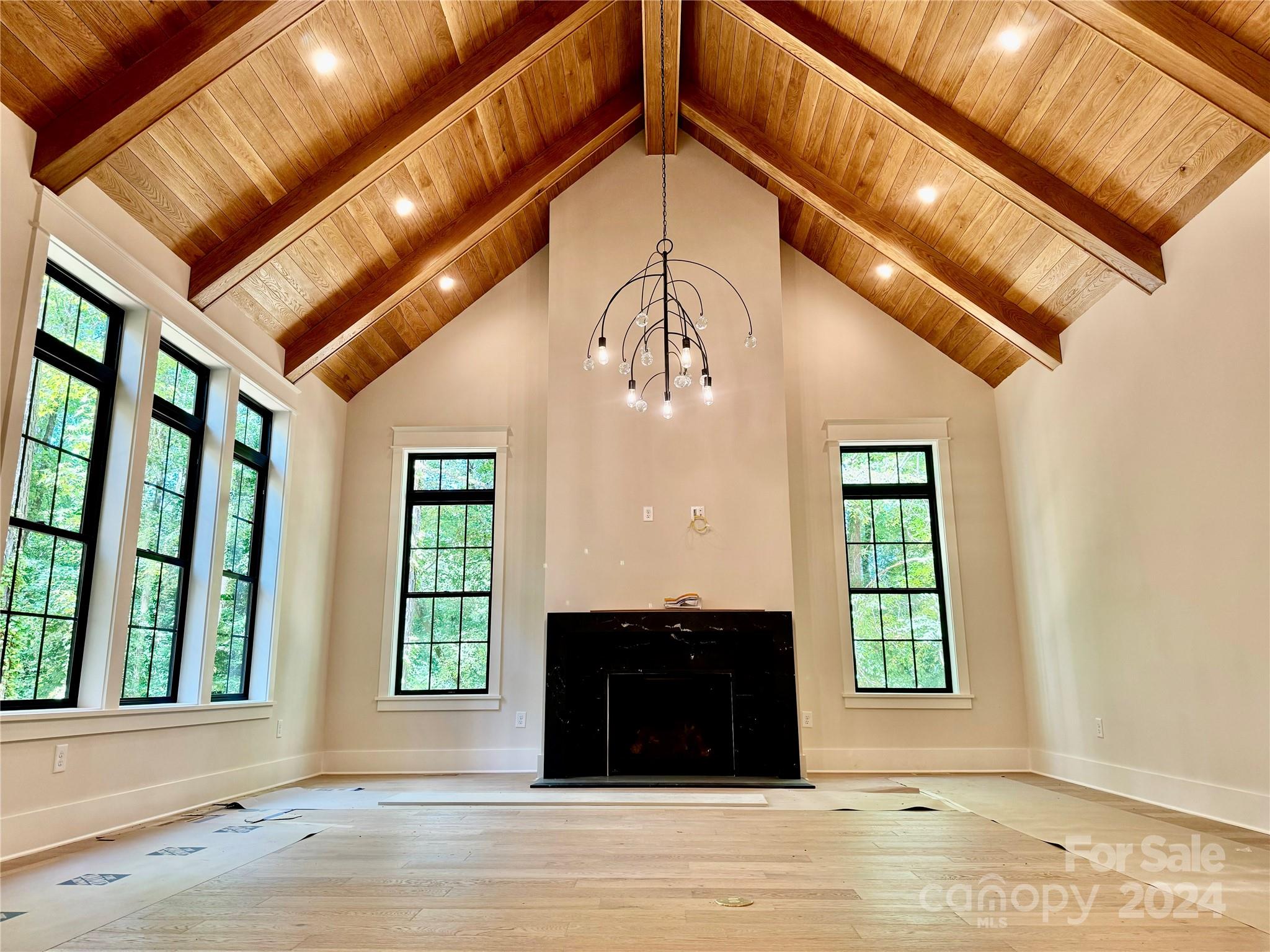 This stunning chateau is hidden in the vibrant Sherwood Forest neighborhood,This expansive luxurious living atmosphere w/ design details that bring nature indoors- this home marries texture, earthy tones & elegant wood designs offering a touch of sophistication to everyday living. Each space is thoughtfully designed to provide a seamless flow, ideal for entertaining and family gatherings. Outside, the property expands into a large, wooded lot full of potential for outdoor activities and adventure, all within your private domain. The expansive outdoor space is perfect for those who cherish nature and seek a tranquil retreat from the bustling city life yet just minutes away from Cotswold Shops, providing convenient access to a variety of shopping options. Offering a perfect blend of luxury, location, and lifestyle, you'll embrace the opportunity to own a slice of Charlotte's charm. Explore this beautiful property and step into your future home.. very soon!
