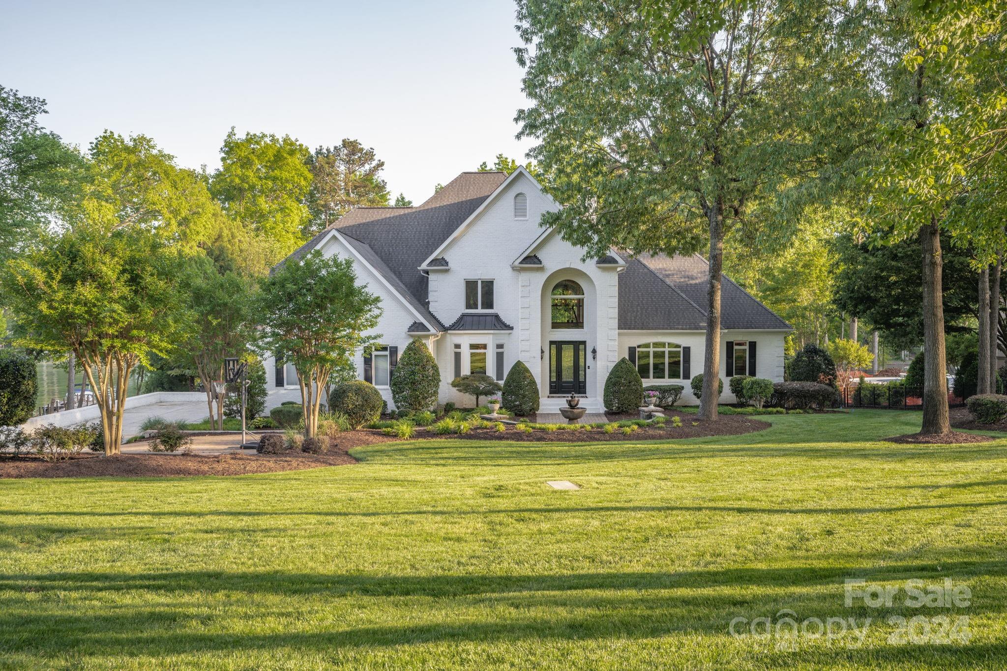 Situated in the exclusive Point community, this home is lake living at its finest. Take off from your private dock, & within minutes, you are at TNGC & a variety of nearby waterfront restaurants & destinations. With a room for everyone, this Elan smart home is a dream. Features include main-floor master suite & office, with 3 bedrooms upstairs &  rec room. Downstairs entertaining space includes a 120” theater screen, large private bar area with Subzero refrigerator, poker area, game room, 2 bathrooms & 2 extra rooms to make into your own wine cellar, gym, craft rm or whatever your heart desires. This home is wired with panels that control lighting, music, temperature & security throughout the home. Outside you’ll find plenty of room for entertaining or relaxing, whether it be a meal on the dock, sitting around the fire pit or dancing by the pool. Upstairs spacious patio allows easy access to the outdoors.  2 AC units, Elan smart home system, & theater all installed since 2020.