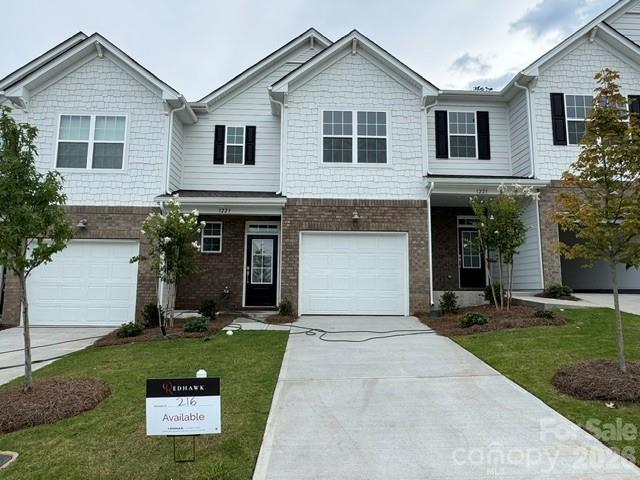 Step right in to our Carlton home! This new two-story interior unit townhome offers 3 generous bedrooms and 2.5 baths.  The first floor features an open design with kitchen island complete with extra seating. Quartz counters, tile backsplash and LVP flooring throughout the main level are just a few of the extras included in this home. Large family room area and dining area are ideal for meals and relaxation. There is also ample space for a desk area. The owner’s suite is upstairs along with two secondary bedrooms. Plus, our signature Everything's Included program means you will get quartz or granite kitchen countertops, subway tile backsplash, ceramic tile, and luxury vinyl plank flooring on the stairway at no extra cost! Redhawk is a master-planned community suited for all ages, offering resort-style living. Amenities planned include two story clubhouse, two swimming pools, playgrounds, tennis and pickleball courts, dog park, disc golf and much more! Located right near downtown Belmont, 30 minutes from Uptown Charlotte and 22 minutes from Charlotte Douglass airport.