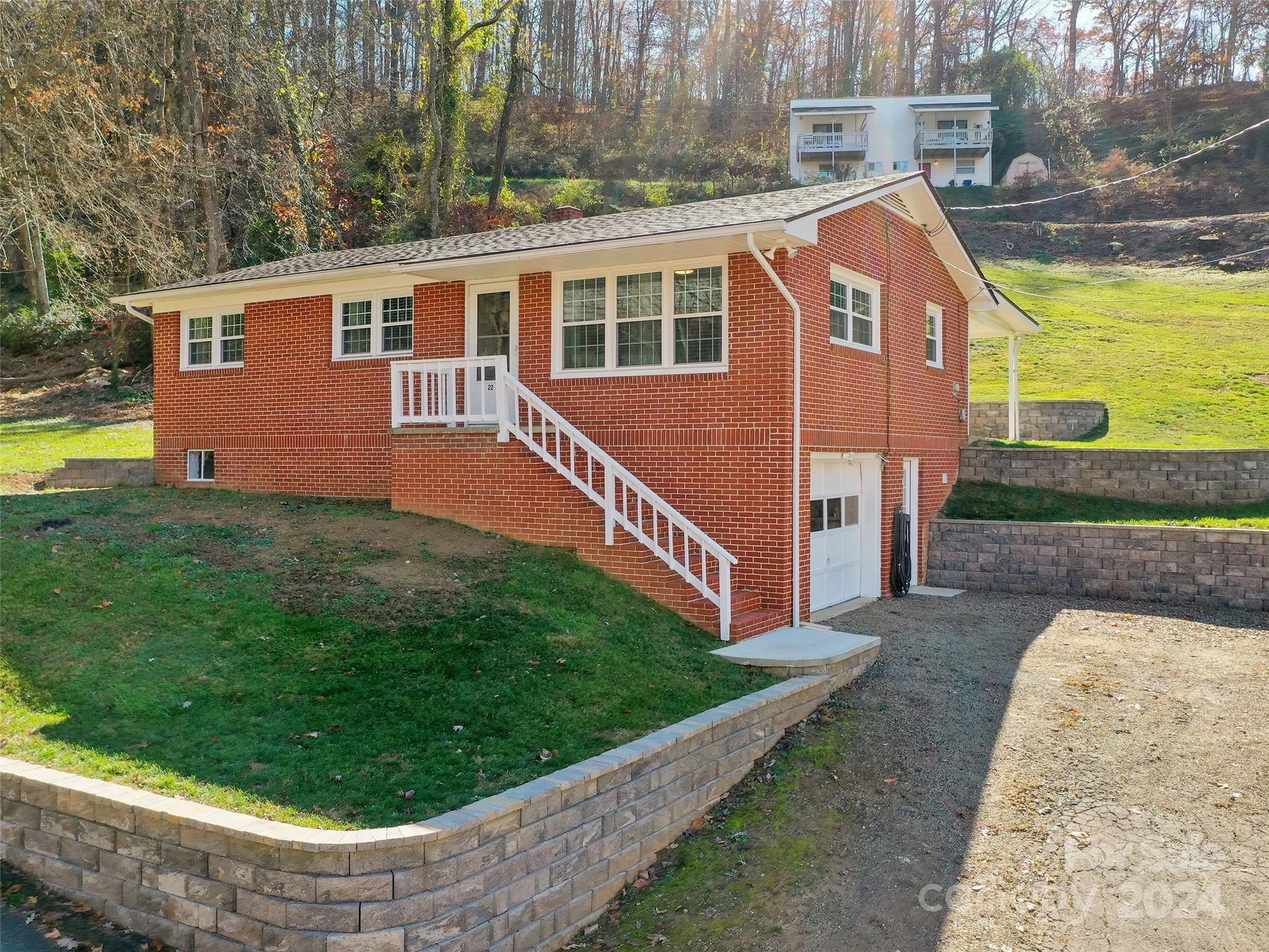 Welcome home to this charming move in ready brick ranch style home located just minutes from downtown
Waynesville. 1,080 square feet of well-appointed living space. 3 bedroom/1 full bath with walk-in-shower.
The home has updated features such as an architectural shingle roof, central air with air purification
system, LVP flooring, windows, retaining walls, huge rear covered patio for entertaining, and updated
soffit and gutters. The basement garage is perfect for storage and the yard is great for relaxation,
gardening, or play.