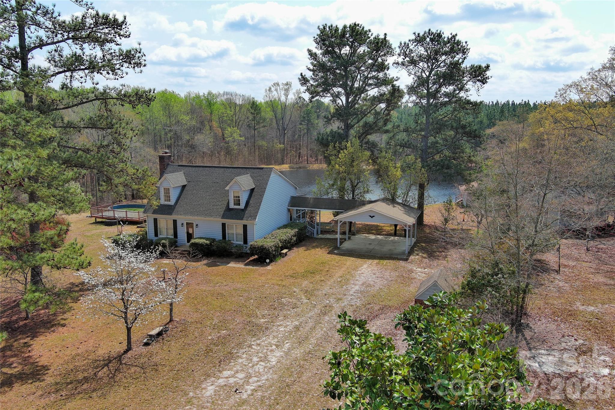 Escape to your own private 71.54-acre retreat in the heart of South Carolina countryside! This beautifully maintained 1983-built 2-story home, paired with a charming separate guest house, offers peaceful 3 acre pond views, abundant wildlife, and endless outdoor living space—perfect for families, hobby farmers, or anyone seeking privacy and tranquility just minutes from Mount Croghan. The main residence delivers approximately 1,971 sq ft of heated living area with 3 bedrooms and 2 full baths. The first floor features an open-concept living room with a cozy gas-log fireplace, spacious dining area, and a bright, updated kitchen with white cabinetry. Whether you are seeking a private family compound or a high potential investments property for AirBnb or events, this estate delivers ultimate versatility. Just steps away, the guest cabin serves as the perfect guest quarters or income producing rental, featuring its own living room, kitchen and bath, with a large deck overlooking the scenic pond. Whether you’re looking for a forever family home, weekend getaway, or peaceful homestead, 819 Triple Creek Road delivers rare acreage, versatile living options, and turnkey appeal at an incredible value. Just 30 minutes to Monroe, hour to Charlotte, and minutes away from White Planes Golf Course.