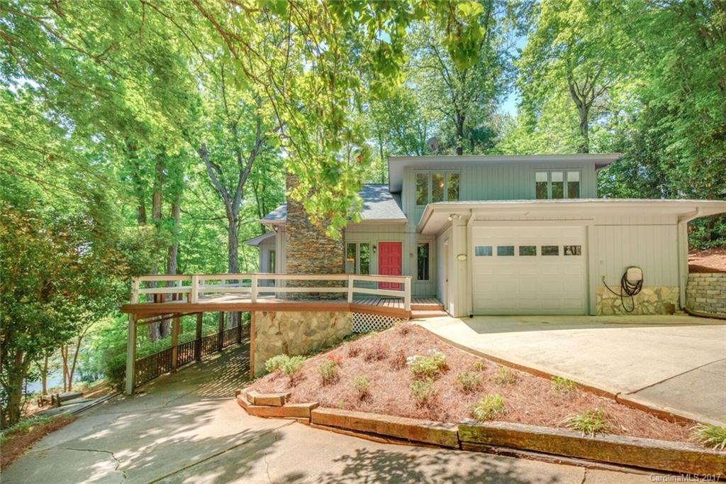 Serenity in this private setting Tega Cay lifestyle waterfront home on three lots.  Pristine condition; updated bathrooms; whole home shows like a model; new hardwood floors, new carpet, paint (inside and out) and much more.  Show this and it will sell itself! Owner has put much TLC in this home. No HOA!