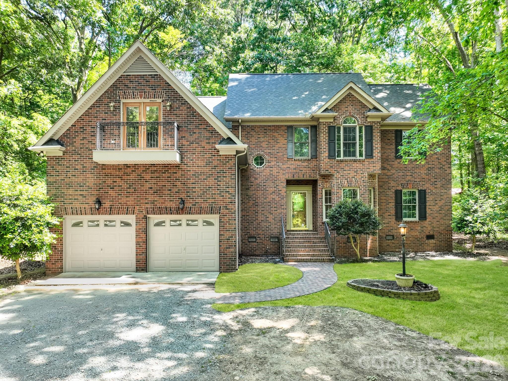 Discover the ultimate sanctuary in this magnificent all-brick estate, tucked away off a quiet gravel road and completely hidden from the street for total seclusion. Situated on 8.87 flat, heavily wooded acres, this property offers a rare blend of grand Southern architecture and peaceful privacy, all while being located just minutes from the recreational amenities of Cane Creek Park and the historic charm of downtown Waxhaw. The sprawling grounds provide a blank canvas for your outdoor dreams, offering plenty of level space to install a custom pool or cultivate an expansive garden. The home’s infrastructure is equally impressive, featuring a private well and a dual septic system, one dedicated to the bathrooms and another specifically for the kitchen and laundry, ensuring long-term efficiency and ease of maintenance.

The interior of the home has been meticulously refreshed with brand-new carpets in the bedrooms, fresh paint throughout, and gleaming hardwood floors across the main living areas. The heart of the home is a dramatic two-story living room, overlooked by a stunning second-story balcony that leads to the spacious secondary bedrooms. Master craftsmanship is evident in every corner, from the heavy crown molding and decorative trim around all windows and doors to the substantial baseboards lining the staircase. The gourmet kitchen is a chef’s delight, featuring granite countertops, a large center island, a stainless steel vent hood, a massive walk-in pantry, and a picturesque window over the sink. The main level hosts the primary suite for ultimate convenience, alongside a large laundry/mudroom and versatile flex spaces on both floors that are perfect for a private library, sewing room, or home office.

Further enhancing this property's versatility is the massive bonus room located over the garage, which comes complete with its own kitchen and half bath, an ideal setup for a guest suite, media room, or multi-generational living. The attached garage is designed with extra-tall ceilings to accommodate additional storage or workshop needs. Whether you are looking for architectural elegance or the quiet lifestyle of a wooded retreat, this home offers the space and sophistication to meet every need. Don’t miss this rare opportunity to own a hidden gem in one of Waxhaw’s most serene settings.

An HOA was created in order to collect a $150 road maintenance fee yearly. If the homeowner does not pay this fee yearly they lose their right to vote at the annual meeting.