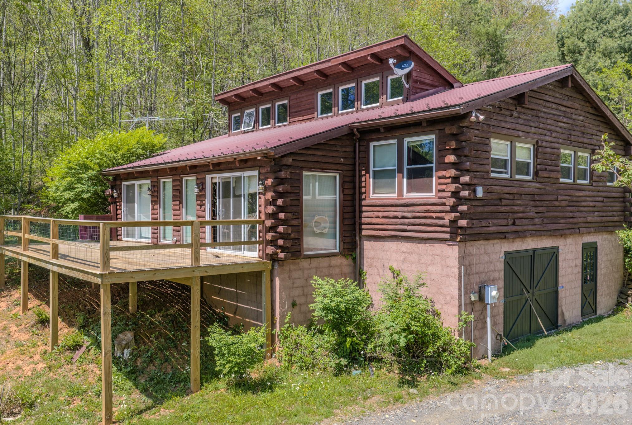 Seller motivated and we would love to hear your offer! Discover 56 acres of breathtaking mountain land with mountain views which include Roan Mountain—a truly rare and versatile property with endless possibilities. With no restrictions or zoning, this unique offering is ideal for a private estate, homestead, retreat, sportsman paradise or investment opportunity. Located at the end of the dead end, gravel road.

The property features a log home with 3 bedrooms and 2 full bathrooms, all conveniently located on the main level. Home offers a sunroom, including a newer metal roof and deck—add both value and peace of mind. A full  basement with garage provides ample space for storage, expansion, or workshop use. The basement could easlly be guest suite. Currently being used as a two bonus rooms, bathroom and kitchenette. 

Beyond the main home, the property continues to impress with multiple additional structures. A separate building with a concrete floor is perfect for an art studio, pottery shop, or workspace. You’ll also find a rustic cabin complete with its own outhouse—ideal for guests looking for a true off-grid experience.

Embrace authentic mountain living with natural features like Cub Creek, which runs along part of the property line, and a two-stall barn with solid roofing and flooring. Some existing fencing is in place and could be restored for livestock or agricultural use.

Tucked at the end of a quiet dead-end road just off Highway 261, this property offers exceptional privacy without sacrificing accessibility. Conveniently located within an hour of Johnson City and Asheville, and about 1.5 hours to Boone, you’re never far from dining, shopping, and amenities. Nearby towns like Bakersville, Spruce Pine, and Burnsville provide everyday essentials.

Outdoor enthusiasts will appreciate being just 25 minutes from Roan Mountain, where you can access some of the most scenic stretches of the Appalachian Trail, including its highest-elevation shelter at 6,285 feet.

If you’ve been searching for privacy, acreage, views, and unlimited potential—this property delivers. Being sold AS-IS/ WHERE-IS. Priced to sell quick. Not in flood zone.