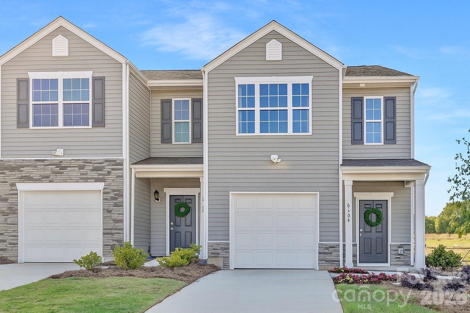 The Maywood is one of our townhome plans featured in our Townes at Troutman community. This spacious and modern home was designed for open-concept living. It offers 3 bedrooms, 2.5 bathrooms, and a 1-car garage.
At the center of the home is the kitchen, which blends the family room and dining room, creating an airy feel. The open kitchen is equipped with stainless steel appliances, granite countertops, a pantry, and a center island with bar seating—perfect for both cooking and entertaining. The Maywood offers a thoughtfully crafted floorplan, striking a perfect blend between modern and comfort. The rooms flow together seamlessly to create an air of harmony and peace within the home. The primary suite is on the second floor, with an en-suite bathroom with dual vanities and a walk-in closet. The additional two bedrooms share access to a secondary bathroom. The laundry room completes the second floor.