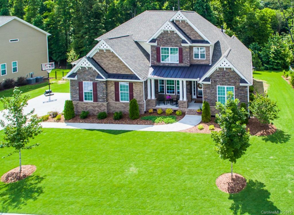 PRICE REDUCTION PLUS AN ADDITIONAL $3,000 IN SELLER PAID CLOSING COST!  Executive home in amenity rich Lake Ridge at Tega Cay. No attention to detail has been spared. Chef's dream kitchen w/large island, granite,custom tile backsplash, gas range, double oven, and large morning room with fireplace. Coffered ceilings and rich moldings throughout. Large Master on main w/sitting area, beautiful master bath with dressing area. Versatile bonus room upstairs. Spacious deck looks onto wooded back yard.