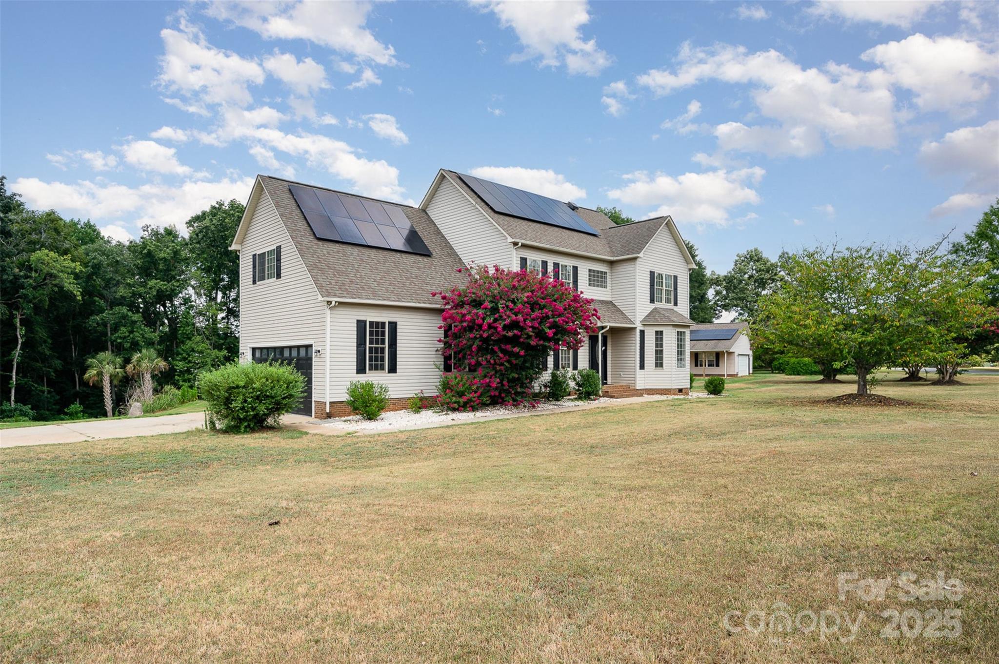 Escape the ordinary and live like you're on vacation every day! This stunning 4 bed, 2.5 bath retreat sits on 2 private acres in York, SC but... it is zoned for award winning Clover schools! The updated kitchen and bathrooms feature granite countertops, new cabinets, and stylish flooring. Step outside to your own private resort: heated zero-entry pool, natural stone grotto waterfall, hot tub that cascades into pool, screened-in patio, detached garage/workshop, sand volleyball court with palm trees, and a dedicated cornhole pad. Pool is full of LEDs and volleyball court and cornhole pad have solar lights. The solar panels are fully paid off and convey with the home! Whether you're entertaining or unwinding, this home delivers and your friends are going to try and move in. All just 10 minutes to downtown York or Clover, and 30 minutes to Charlotte. This is more than a home, it’s your new lifestyle.