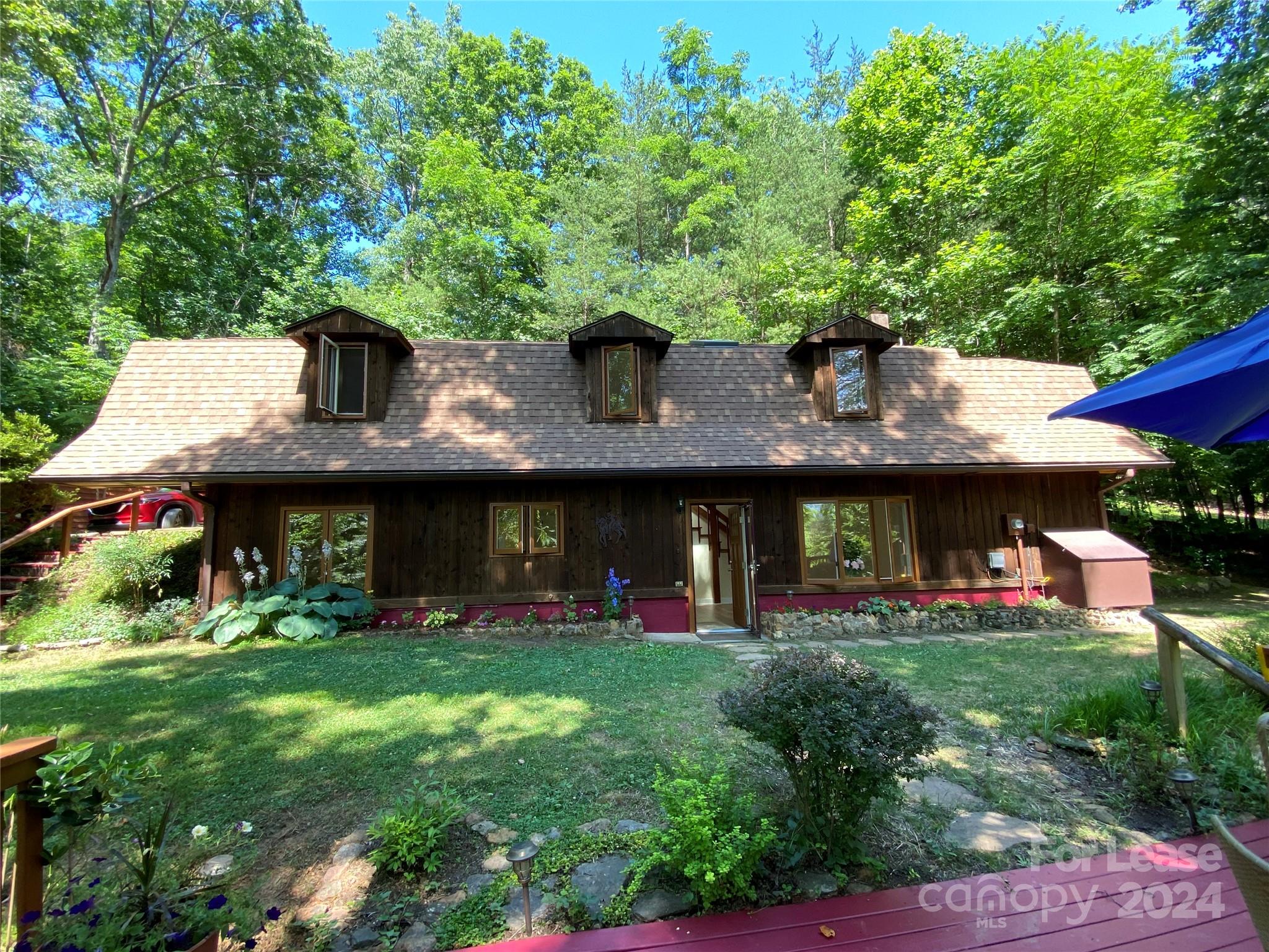 Enchanting storybook cottage available for rent a truly unique property like no other! Amazing open floor plan with loft and catwalk. Private knoll of wooded bliss with wonderful mountain views! An artistic treasure with an open concept ,gas fireplace, vaulted ceilings, balcony off upstairs private primary bedroom suite.2 bedrooms with additional bonus space for office.(or could be used as third small bedroom)Lovely deck overlooking mountains and gardens, nature abounds, sit and listen to the quiet and birds singing! Detached workshop/studio with two covered car ports, bench ,equipped with full electric ,new LED lighting fixtures ,heat source ( propane) would make a wonderful artist /woodworker studio!.All new appliances including stackable washer and dryer,dishwasher,electric range/stove and refrigerator. New quality vinyl plank flooring and solid red oak staircase.Truly a nature lovers paradise with hiking trails and more. Only 20 minuets to Asheville, all shopping within 10 minuets.