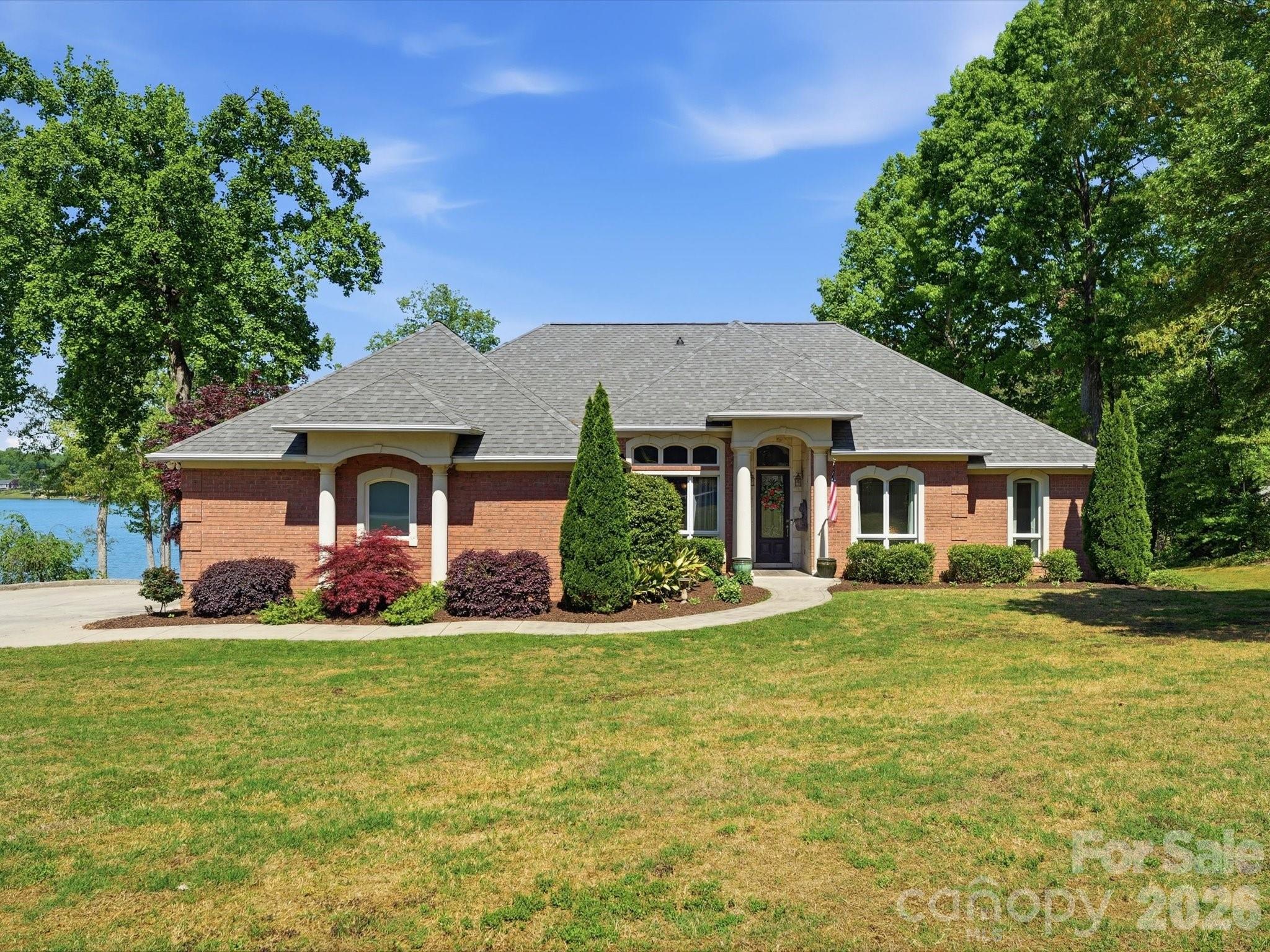 Stunning waterfront home on tranquil Moss Lake! With 132' of deep water lake frontage and a two tier dock with boat lift, this home offers lake life at its finest. The large kitchen with stainless appliances, granite countertops, eat-in bar, and custom cabinets opens up to the breakfast nook, spacious living room, and newly added (April 2026) sunroom, all overlooking the water. The owner's suite has a private walkout deck, and the custom owner suite bathroom features his-and-hers vanities, a large jacuzzi tub, walk-in shower, and oversized walk-in closet. Two-car main-level garage has a 50-amp service ready for your electric car. Downstairs boasts a second full kitchen and laundry, living area, breakfast area, and three full rooms perfect for a second office, home gym, theater room, or guest rooms. The basement level also features an additional garage with 30-amp service, workshop space, and an expansive covered patio area, perfect for hosting. Recent major systems upgrades include: HVAC (both units 2023), roof (2025), water heaters (electric in 2024; gas in 2023), and sunroom windows (2026). The back of the home facing west-northwest, the views of the sunset over the water are nothing short of breathtaking. From the thoughtful finishes, flexible spaces, and outdoor oases, this home is an entertainer's dream and a lake lover's paradise.