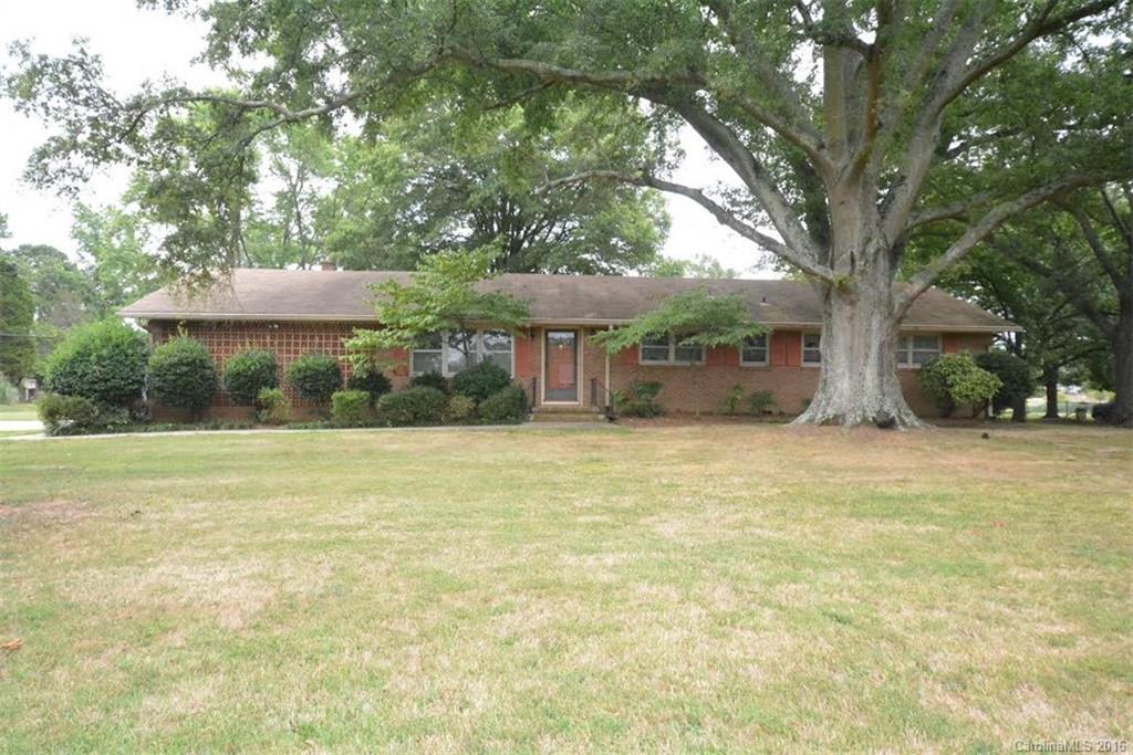 So much potential with this 4 bedroom, 2 bath home!  Large family room, formal living room, large laundry room, spacious kitchen & dining room.  .82 acre lot.  To be sold as is - priced accordingly.  Beautiful magnolia tree, pecan tree, rose bushes and flower beds throughout yard.  Great closet space throughout the house.  2 car attached carport with storage room.  No city taxes! Well and septic.  Hardwood floors under carpet per owner.  Tons of possibilities for this house!  Call to see.