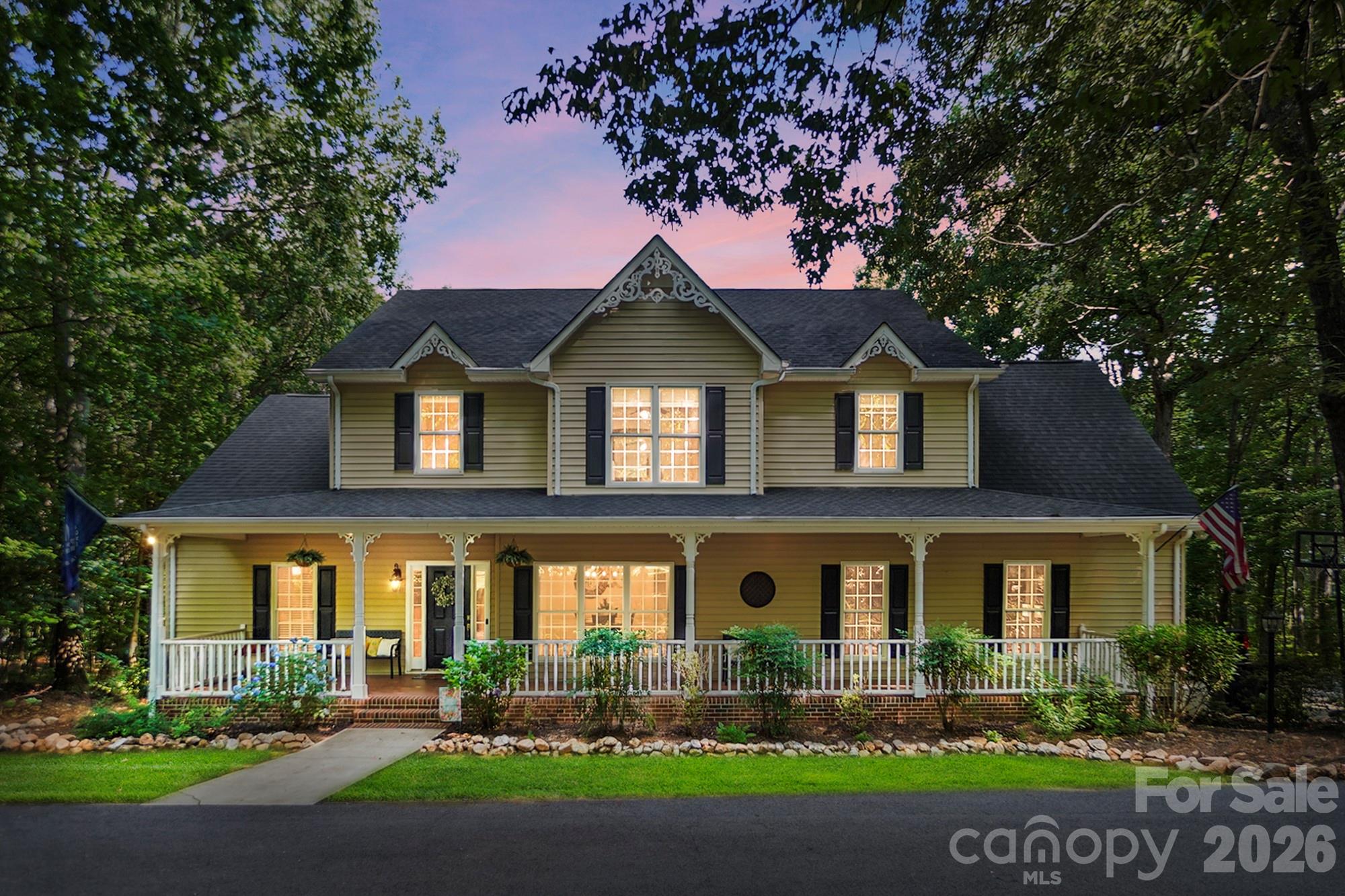 Beautifully maintained home featuring a welcoming rocking chair front porch and a spacious, inviting layout. The family room flows into a well-appointed kitchen with quartz countertops, a center island, and a pantry, while the formal dining room is perfect for gatherings.

The main-level primary suite offers double closets for ample storage and convenience. Upstairs, you'll find three spacious bedrooms, including one with a private ensuite bath, as well as an additional full bathroom. There is a flex space on the second floor as well. 

The finished walk-out basement provides even more living space with a large family room, office, and full bath, making it ideal for guests, recreation, or working from home.

Enjoy outdoor living on the expansive deck just off the kitchen, complete with a separate screened-in porch overlooking the beautiful, tree-lined backyard that offers exceptional privacy. The partially fenced backyard provides space for pets or play while maintaining the natural setting.

Additional highlights include a tankless water heater, a dedicated well for irrigation, and a fully wired shop/outbuilding, adding both convenience and versatility to this exceptional property.