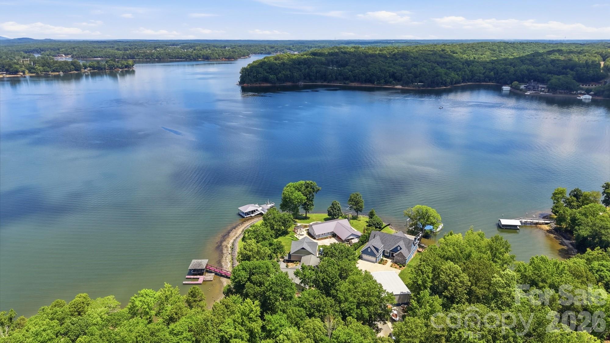 Showings begin Sunday, 6/21 at 11 AM!

This is where land ends and life truly begins. Situated on the main channel of Lake Wylie, this must-see waterfront home is less than six years old and offers the perfect blend of luxury, functionality, and the lake lifestyle you've been dreaming about.

The vaulted great room is filled with natural light and features custom built-ins flanking the fireplace. The open-concept design flows seamlessly into the chef's kitchen, complete with high-end appliances, a walk-in pantry, a spacious island with bar seating, and a dining area overlooking the water.

The main level features a private office, a luxurious primary suite with dual walk-in closets, dual vanities, and a massive walk-in shower, as well as a secondary bedroom with an ensuite bath. You'll also appreciate the spacious laundry room with sink, drop-zone cabinetry, and an oversized attached garage with a partitioned storage room that is perfect for a workshop, hobby space, or additional storage.

Step through the large doors into the four-season room, complete with screens and vinyl inserts for year-round enjoyment. Outside, you'll find a lakeside patio with a built-in grilling station and ice machine, a hot tub, and just a few steps to the water's edge where a custom dock awaits. The dock features a covered seating area, two boat lifts, and a floating platform ideal for sunbathing, swimming, and easy boarding of your boat.

One of the most unique features is the impressive 40' x 50' detached shop. Whether you need space for an RV, multiple boats, classic cars, a workshop, or all your recreational toys, this building delivers. It features two 12-foot-tall roll-up doors on one end and a 14-foot-tall RV door on the other, providing exceptional drive-through access and flexibility. Properties offering this combination of a newer waterfront home, private dock, and a shop of this size are extraordinarily rare on Lake Wylie.

Located in the heart of Lake Wylie, you'll enjoy quick access by boat to marinas, waterfront restaurants, skiing coves, and your favorite fishing spots. By car, you'll appreciate the convenient commute to Charlotte Douglas International Airport, Uptown Charlotte, major hospitals, shopping, dining, and entertainment. Add in low South Carolina taxes and the award-winning Clover School District, and it's easy to see why opportunities like this are so hard to find.

If you've been searching for a waterfront property that offers luxury living, room for all your toys, and true main-channel lake access, this is the one. Don't miss your chance to own one of Lake Wylie's most unique and desirable properties