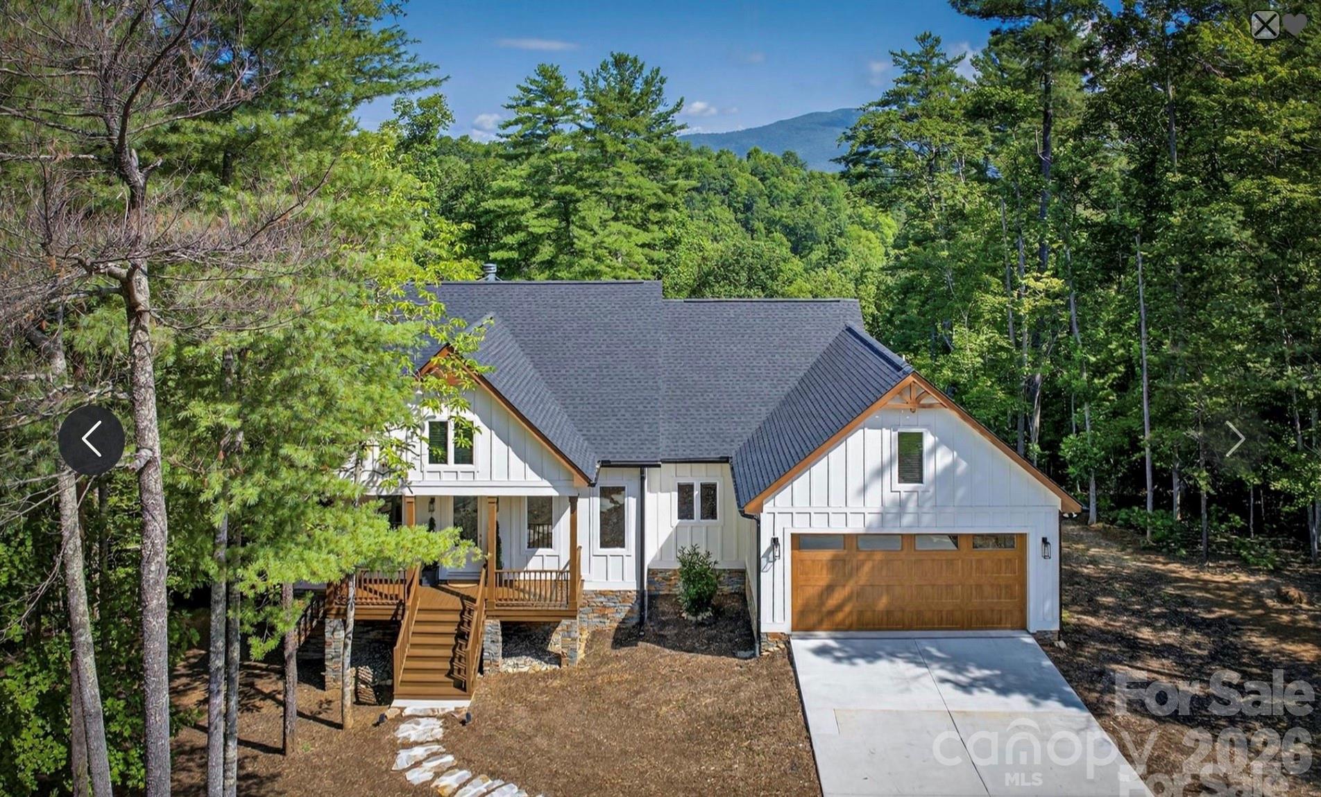 Gorgeous 2025 move-in ready custom built home with deeded boat slip on Lake James! Featured in The Arbor, one of Lake James' most cherished gated communities, this home has stunning up close year round mountain views framed by lush green forest. Clean, sophisticated design and upscale mountain elegance combine for this truly unique lake community home. With absolute attention to detail, upgraded finishes and superior craftsmanship this one of a kind home is designed to be bathed in light. With expansive windows, 8 foot glass doors, and 10 foot ceilings you’ll feel like you’re truly living in the forest. And upscale Allure siding with Sherwin Williams paint inside and out deliver superior all weather protection. The open concept great room features an oversized ‘Biltmore’ wood burning fireplace and 12 foot Pella sliding glass doors that open the room to full length decks with stunning views. There’s 3 more decks below and one already plumbed for a hot tub. A large green yard complete with fire pit, BBQ, and picnic area lends itself to long evenings and easy conversation. Wide plank Chesapeake oak floors, Medallion cabinetry, and leathered quartz with Kohler fixtures give the home a bright and polished feel that’s modern yet cozy. The gourmet kitchen has an oversized mountain view and features a baker's oven, butler’s pantry with sink, wine cooler and oversized pantry cabinets. The spacious primary suite has recessed ceiling, private balcony access, and a custom closet with window seat, while the spa like ensuite includes a three head shower designed for both comfort and function. Guest rooms provide deep closets, built ins, and a direct balcony access. Guest bath features a cast iron tub and spa style shower. An oversized two car garage with easy level drive opens to the mudroom making unloading items easy. A separate approximately 400 square foot studio with private exterior access offers endless options. Perfect for guests, it sleeps 4 with bunkbeds and corner beds or could easily be game room, home office, or art studio. It has a full bath, vanity, sitting area and large walk-in closet. There is also direct access to an unfinished conditioned area that provides over 300 sq. ft of additional storage area as well as a work area. Recent enhancements include brand new boat docks with electricity and water, along with fiber optic for high-speed internet. Short term rentals are allowed. The Arbor at Lake James is a premier active-lifestyle community offering miles of hiking trails, lakefront community space with direct lake access, a pavilion with a large fireplace, and optional boat storage for an additional fee.