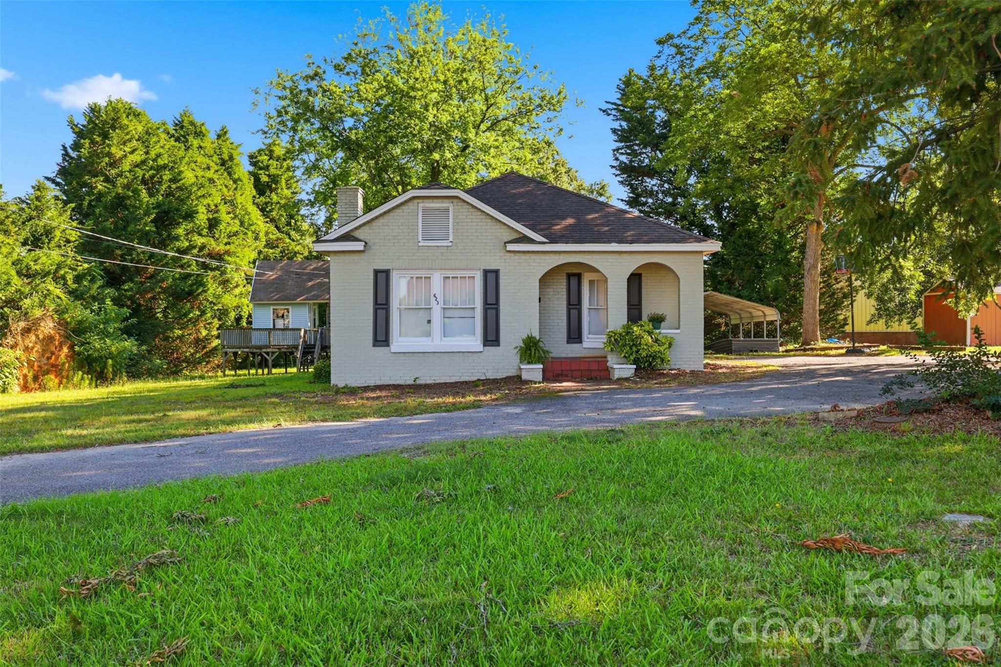 Welcome to 623 E Ohio Avenue in Bessemer City, where timeless character meets thoughtful updates on a spacious, tree-lined lot. This 3-bedroom, 1.5-bath home offers the perfect blend of classic charm and modern convenience, creating a warm and inviting place to call home.

Step inside to discover a bright living room centered around a beautiful painted brick fireplace, providing the perfect gathering space for relaxing evenings or entertaining guests. The updated kitchen features abundant cabinet space, stylish countertops, stainless steel appliances, and a functional layout that makes cooking and hosting a breeze.

Outside, you'll appreciate the expansive yard shaded by mature trees, offering plenty of room for gardening, outdoor activities, or simply enjoying the peaceful surroundings. 
Whether you're looking for your first home, more space, or a property with character that's move-in ready, this home delivers comfort, charm, and value in a convenient Bessemer City location.