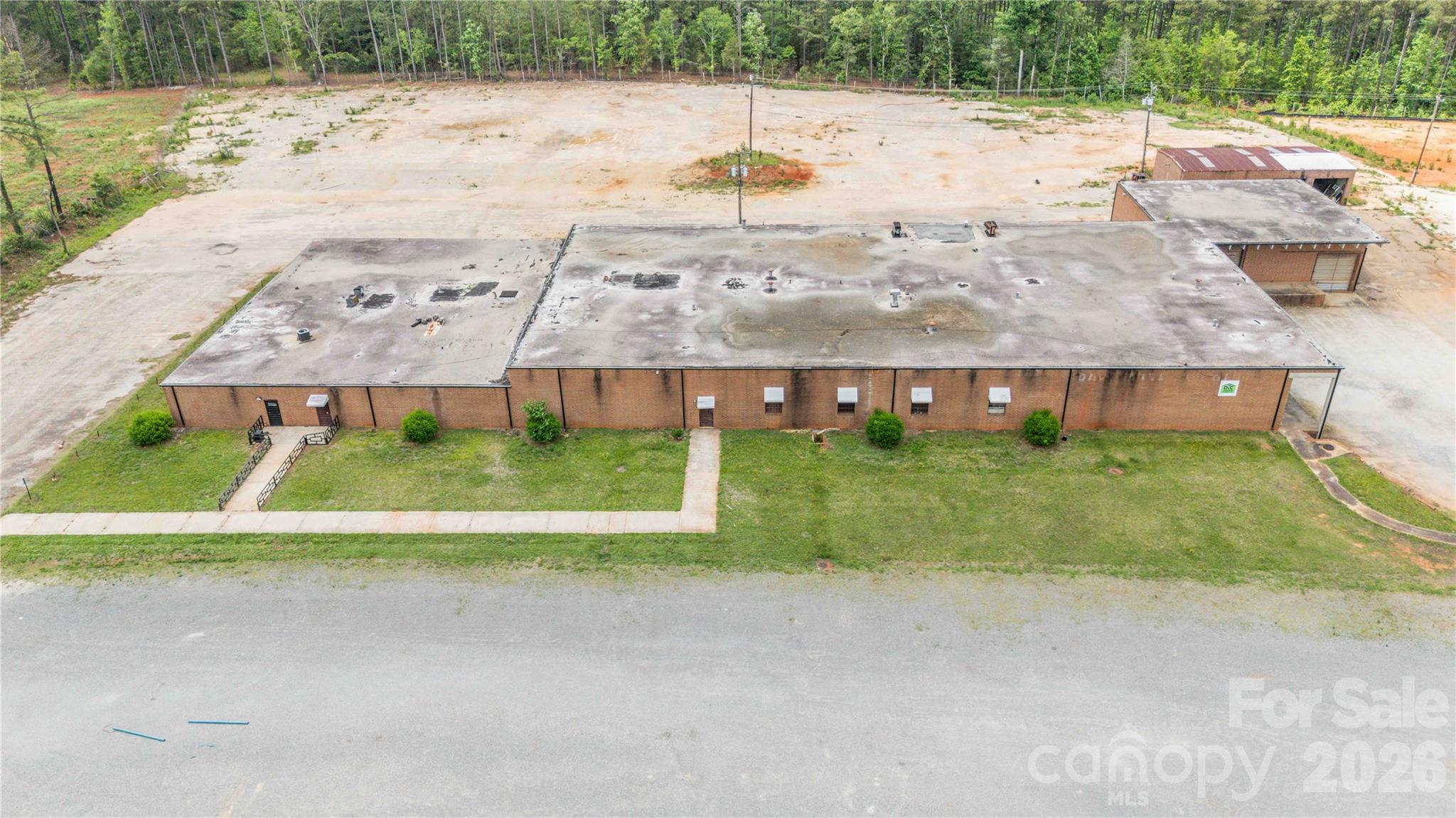 This versatile industrial/commercial opportunity offers over 30,000 SF of brick construction situated on 8.67 acres in rapidly growing Lancaster County. The expansive building features multiple separated sections ideal for office space, warehouse operations, storage, showrooms, manufacturing, distribution, or flexible multi-tenant use. Multiple loading docks service the main building, providing excellent accessibility for shipping and receiving operations. Heated and cooled office areas offer comfortable workspace, while the remaining portions of the building provide substantial open industrial space ready for customization.
A front parking lot accommodates customers and employees, with additional land behind the building offering potential for expanded parking, storage, or future development. A detached storage building further enhances the property's functionality and flexibility.
This offering becomes even more attractive with an adjacent parcel available for purchase. The adjoining parcel consists of approximately 12 acres of partially cleared raw land with existing driveways installed. All parcels have been county-approved for use as a concrete plant, creating exceptional potential for industrial users, contractors, manufacturing, or expansion operations.
Located in Lancaster County, an area known for aggressive industrial incentives and continued growth, this property presents a rare opportunity for investors, owner-users, or expanding businesses seeking flexibility, acreage, and future development potential.
Please note, this property is also listed for lease with MLS #4379966.  Refer to MLS #4380263 for the sale of LOT B and MLS #4380266 for the lease of LOT B.