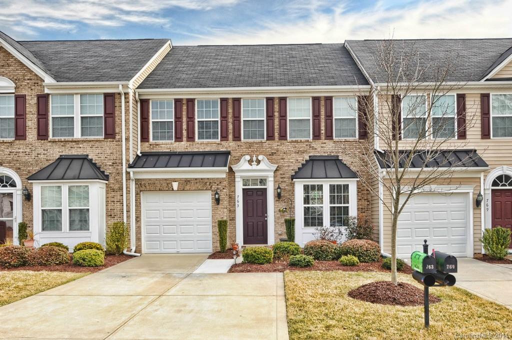 Spacious townhome with master down! Bright kitchen w/tile backsplash, solid surface countertops. 2-story family room with lots of windows,gas fireplace.  Upstairs boasts 2 bedrooms plus loft area, great for office/flex space! Large closets. Private in back, view of woods. Additional storage you won't believe! Close to Interstate and shopping! Yard Maintenance, irrigation, exterior insurance, trash p/u included in HOA.  This home has been meticulously maintained and super clean! Ft. Mill Schools