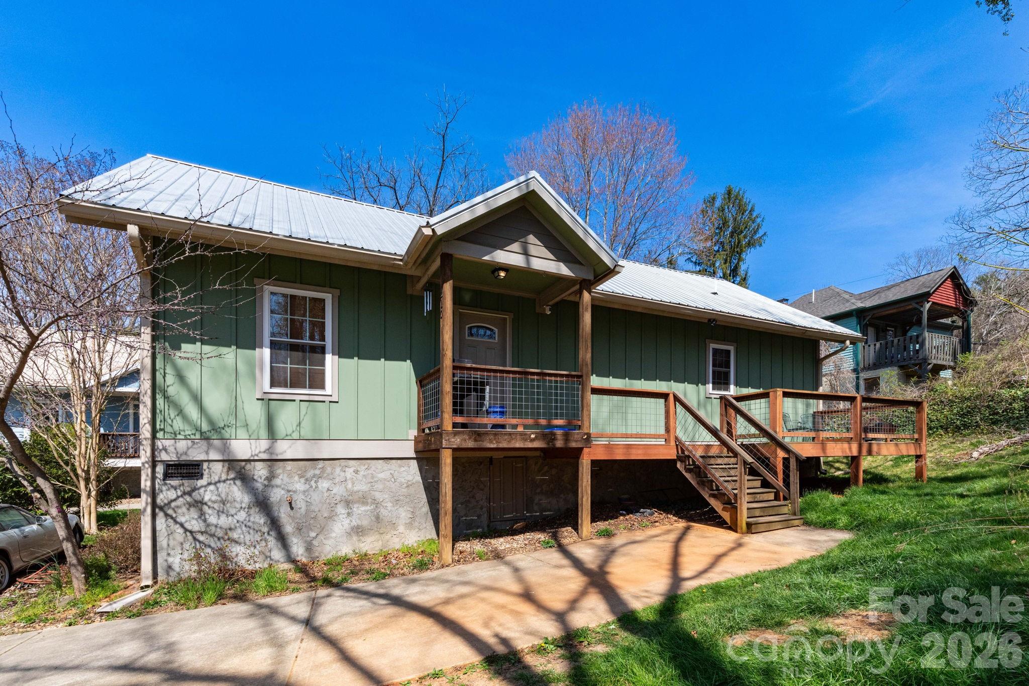 Charming cottage in a prime West Asheville location. This inviting home features an open floor plan, hardwood floors, and a spacious great room with a tray ceiling. The kitchen offers an island with bar seating, stainless steel appliances, granite countertops, and solid wood cabinets. The primary suite includes a private bath, while two additional bedrooms provide space for guests, an office, or hobbies. A wonderful opportunity to own in one of Asheville’s most desirable areas!