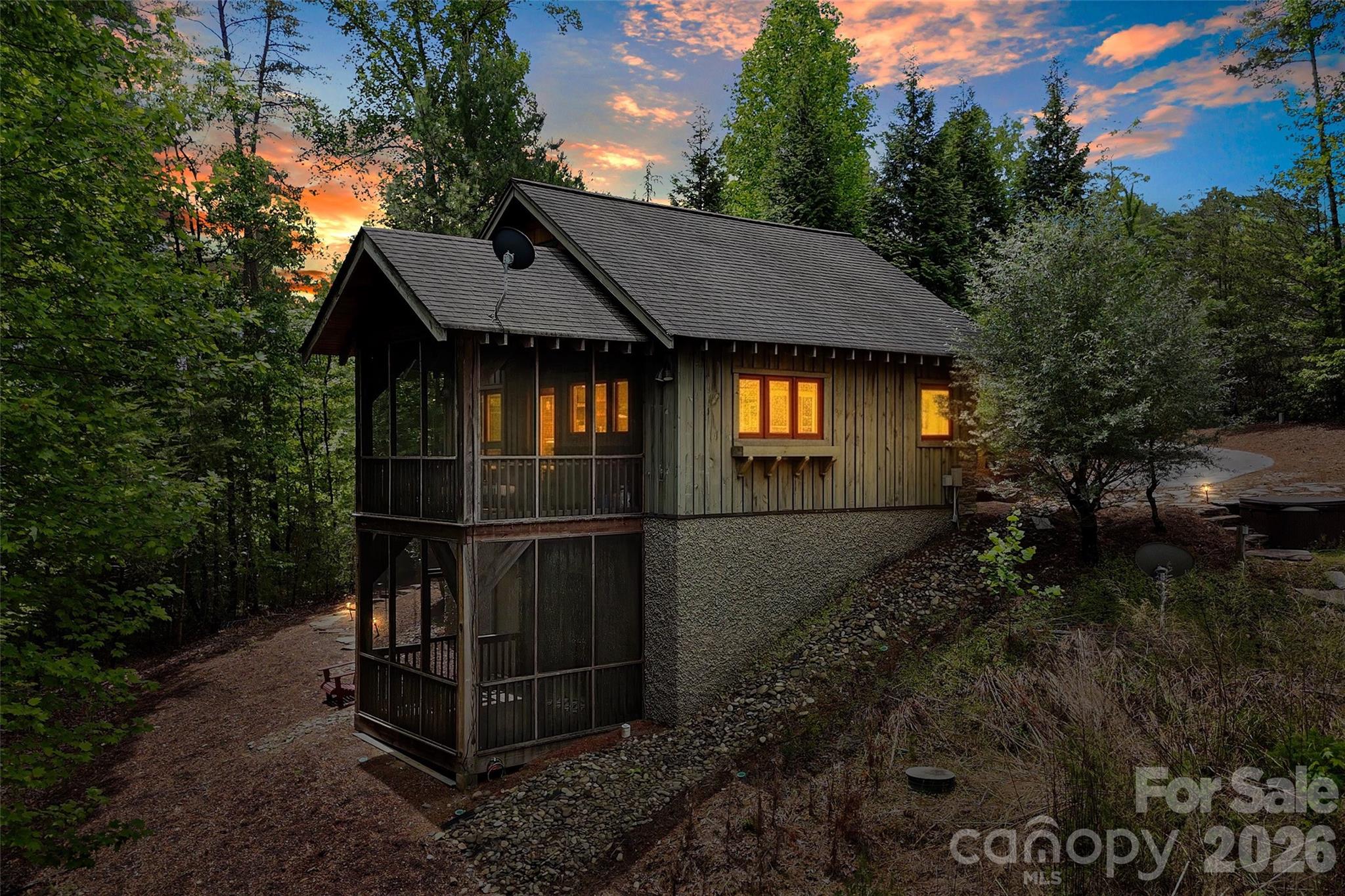 A rare Lake James opportunity in the sought-after Old Wildlife Club community—159 Osprey Roost Drive offers 1.25 acres of pristine waterfront living, a deeded boat slip a short walk away through the community, and the infrastructure already in place for future expansion.

Originally built as a temporary lake retreat with the intention of later converting the structure into a garage once the main home was built, this charming cabin now offers comfortable turnkey living with endless potential. The property includes a 5-bedroom septic permit/system, creating a valuable head start for those dreaming of building a full-size custom lake home.

The existing cabin features one bedroom and one full bath upstairs, as well as an upstairs loft, plus an additional bedroom and half bath downstairs. Two screened porches invite you to slow down and enjoy the peaceful surroundings, while professionally designed landscaping by Appalachian Hardscapes adds thoughtful beauty to the setting.

Additional features include a 30-amp RV hookup with hot tub service already in place, radon mitigation system, monitored alarm system, and an active termite bond for added peace of mind.

Sold turnkey and including both indoor and outdoor furnishings, this property is ready to enjoy immediately—whether as a private lake escape, future dream home site, or investment opportunity.

Adding to the privacy, the adjacent 4-acre parcel belongs to the Old Wildlife Club community, helping preserve the natural buffer and giving the property a tucked-away feel.

Ownership also includes membership access to Camp Lake James, offering resort-style amenities including swimming pool, fitness center, pickleball courts, paddling access, gathering spaces, and on-site dining options exclusively available to community members and guests.

This is a truly unique chance to secure pristine Lake James waterfront property with valuable infrastructure, privacy, amenities, and future potential already in place.
**Also Listed as Land - See MLS# 4388744 **