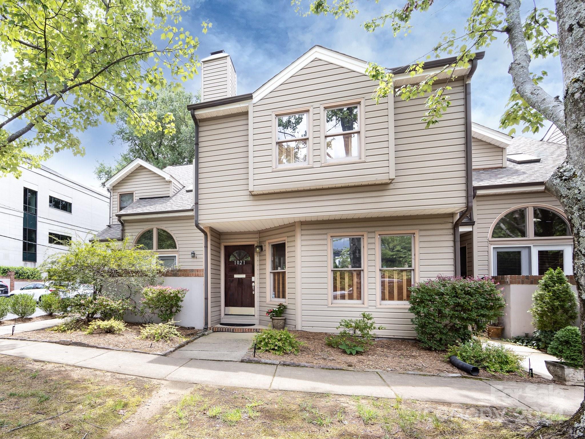 Fresh new look!!!  Entire unit painted with neutral tones.  Spacious and charming two story unit in heart of Historic Dilworth!  8 unit complex is self managed with low HOA dues. Exterior maintenance (other than private courtyard) is covered by HOA.  Great floorpan features kitchen with granite countertops and decorative tile backsplash, stainless stove/dishwasher  and painted white cabinets. Kitchen has bar seating and opens to Dining Room.   Soaring two story Great Room with wood burning fireplace. Laundry on main level with full size stackable washer dryer that conveys.  Huge Primary Bedroom upstairs with double closets and window seating area.  Second BR has loft overlooking Great Room and double closets.  Huge walk in attic area is fully floored.... great storage! Two assigned parking spaces!! Stroll down the sidewalk to popular Dilworth restaurant/shops plus close to Latta Park. Such an ideal location......also convenient to Uptown, Interstates and new Atrium teaching hospital.
