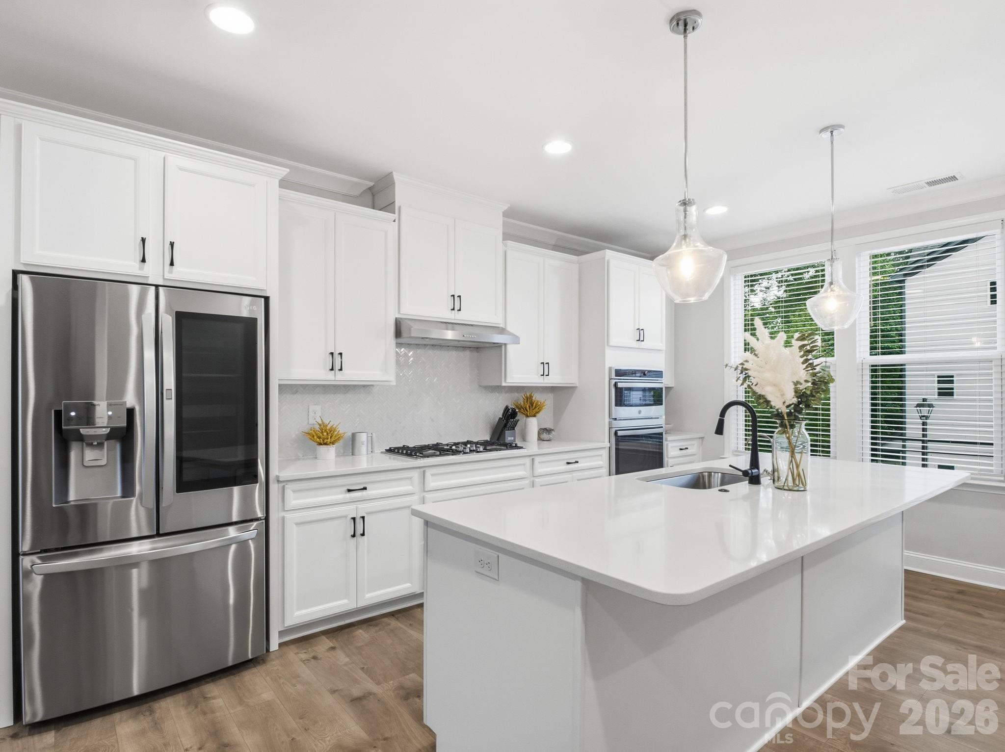 Some homes simply check the boxes. This one creates possibilities.

Tucked into one of Ballantyne's most convenient locations, this four-level townhome offers the flexibility today's lifestyle demands and the spaces you'll actually use. Step inside from the front door and you'll immediately discover a rare bonus—a spacious flex room with a full bath on the entry level. Whether you envision a home office, fitness studio, media room, playroom, or a guest retreat, the choice is yours.

Upstairs, the heart of the home comes alive. The open-concept main living area is filled with natural light and designed for gathering, whether you're hosting friends around the oversized island, enjoying dinner together, or curling up for a quiet evening at home. The seamless flow between the kitchen, dining area, and living room creates an inviting atmosphere that's both stylish and comfortable.

The third floor offers three bedrooms, including a spacious primary suite designed for relaxation after a busy day, while the two additional bedrooms can easily be used as bedrooms, a dedicated office, nursery, or creative space. Laundry is conveniently located nearby, making everyday living just a little easier.

Then comes the space that truly sets this home apart—the private rooftop terrace. Imagine morning coffee as the neighborhood wakes up, afternoons spent soaking in the sunshine, and evenings under the stars with friends and your favorite playlist. It's the perfect extension of your living space!

Located just minutes from Ballantyne's shopping, dining, entertainment, parks, and top-rated schools, this home offers the ideal blend of convenience and connection. Beautifully maintained and move-in ready, it's waiting for its next owners to turn the page and begin their own story.