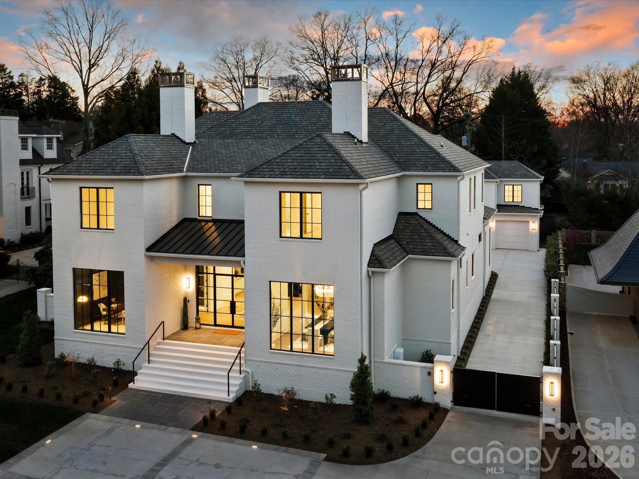 Welcome to this one of a kind custom, new construction build on the prestigious and picturesque Queens Road West! This luxury home is bursting with features and upgrades that make it a real show stopper. The first floor features 12'-14' ceilings, an oasis like primary suite, dedicated study & dining room, butlery area, and prep kitchen.  An open concept kitchen with Sub-Zero/Wolf appliances flows into the living room accented with an oversized linear fireplace extending to the 14' tall ceiling. The second level features four bedrooms all with their own en suite bathrooms, laundry room, and large media room with half bath. The exterior is an entertainer's dream, featuring a screened in covered porch with wood burning fireplace, open terrace, in-ground swimming pool & spa combo as well as an outdoor kitchen cabana and pool bath. The detached three-car garage has a finished space above, with a full bathroom, wet bar, loft, and flex space for a gym or office. Don’t miss this!