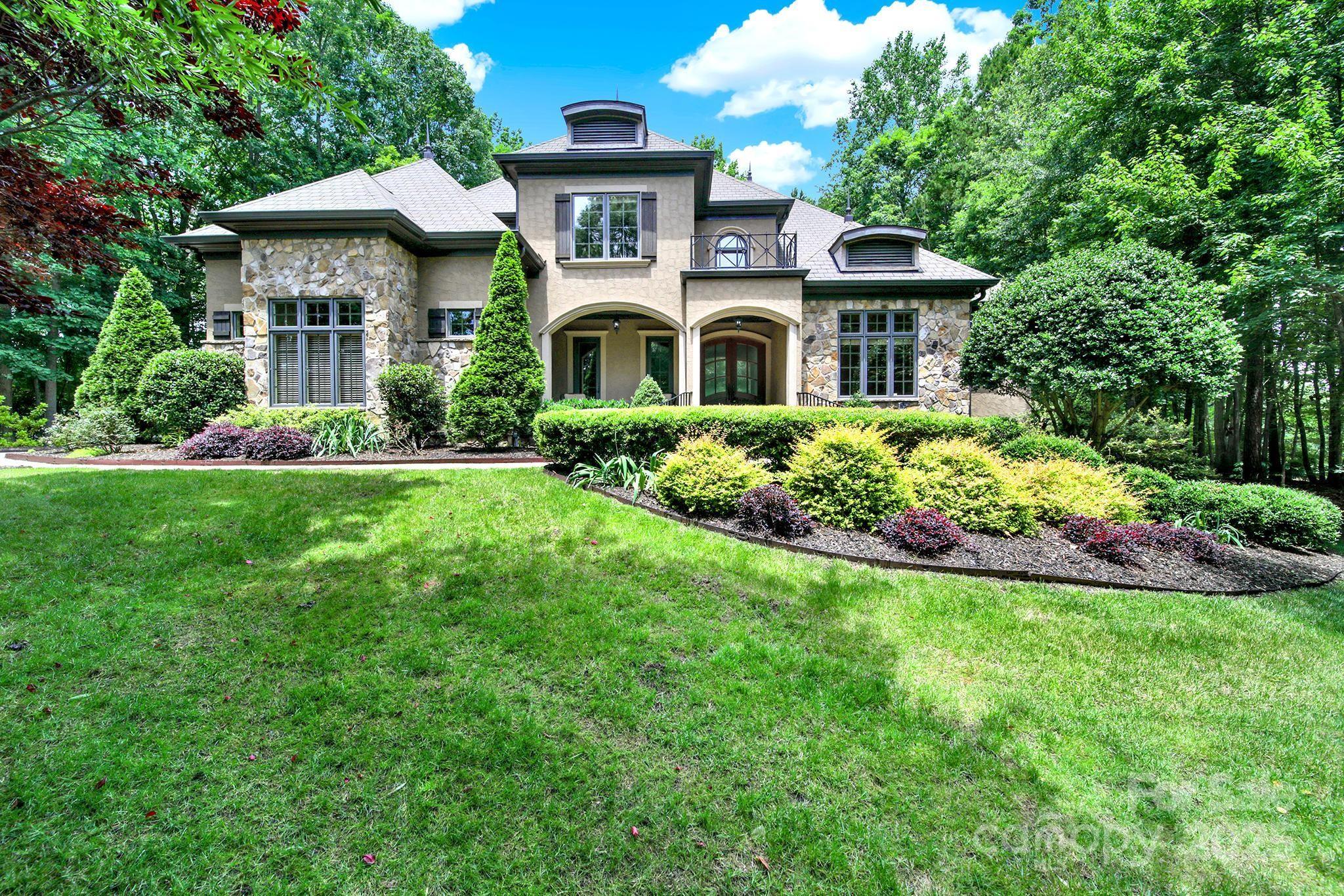 Don't miss this gorgeous custom estate home located in the highly desired Springfield community. Golf course lot with plenty of wooded privacy on this almost 1 acre lot. Recent updates include new white oak hardwoods throughout, kitchen countertops and backsplach, interior paint, and lighting. With spacious primary suite and office on main, and additional 4 bedrooms and a bonus upstairs this home has it all- luxury, space, and prime location. Added bonus- laundry rooms on both main floor and upstair as well! Springfield offers tennis courts, 3 pools, pickle ball, playgrounds, walking trails and an Anne Springs Greenway membership.