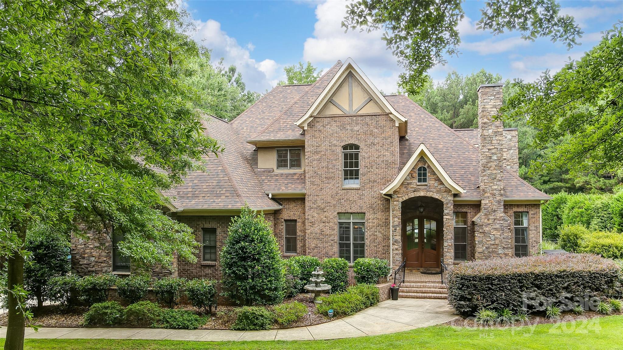 This home is fully loaded with a bonus room, home theater, 3 fireplaces, a backyard oasis, and more. The piano/sitting room welcomes you with a gas fireplace. The gourmet kitchen features S/S Bosch appliances, granite, and a custom walk-in pantry. The adjacent living room is adorned with a 2nd gas fireplace and custom built-ins. The primary suite features an adjoining room perfect for a home office or gym. Step outside the PBR to a covered back porch, leading directly to the pool deck. The all-season room has a wood burning fireplace and overlooks the pool. The heated saltwater pool/hot tub includes a tanning shelf, two waterfall features, and beautiful landscaping. The outdoor kitchen is equipped with a new natural gas grill, bar fridge, and a freshly re-tiled bar top. A recently added 11'x24' pergola with fans and lighting creates a seamless blend of comfort and sophistication. Upstairs, discover 3 more bedrooms each with walk-in closets, a bonus room, and a media/home theater room.