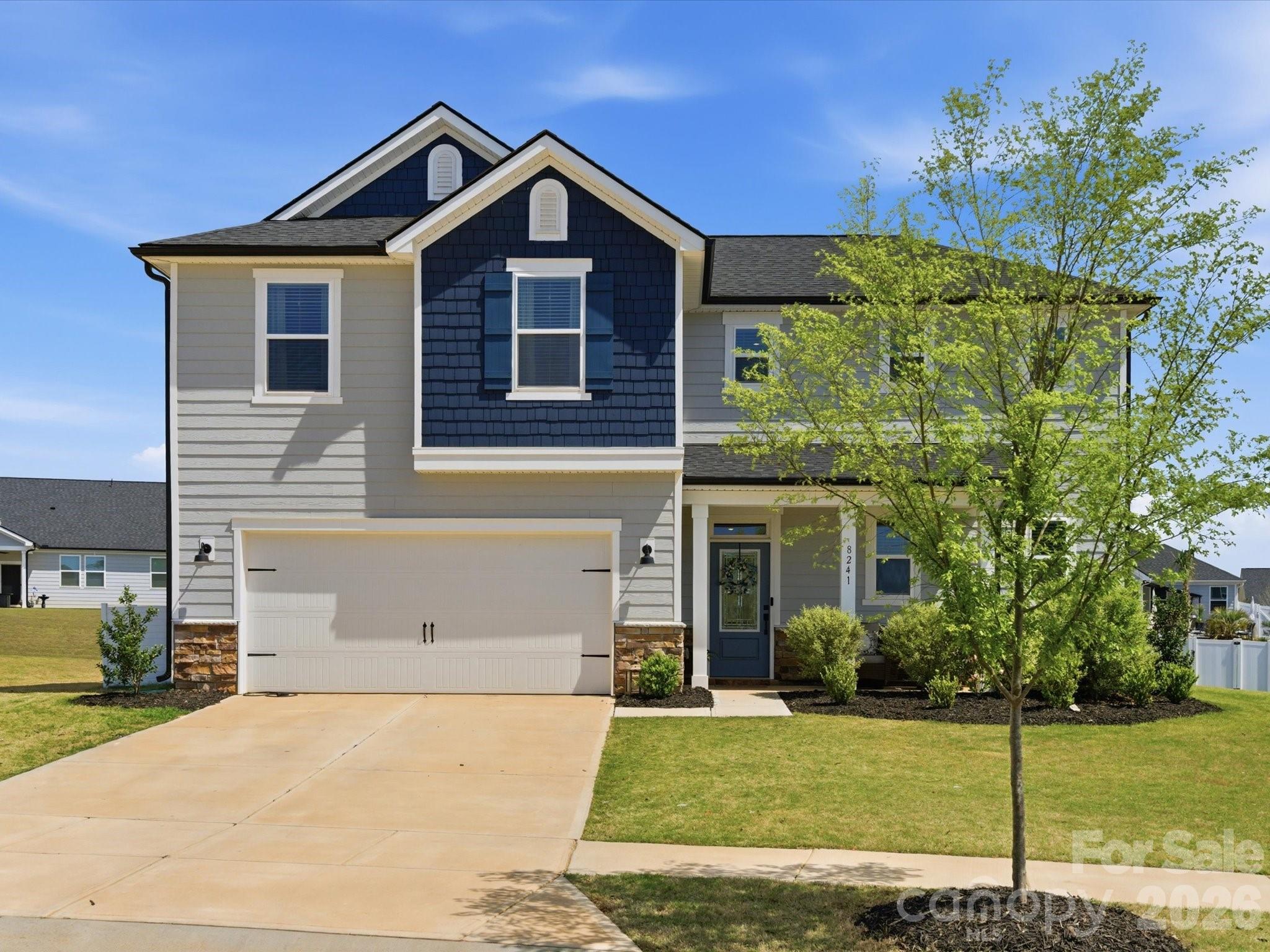 Welcome home to this 4-bed, 3.5-bath home in the sought-after Wilson Creek community in Indian Land. Perfectly positioned just minutes from downtown Waxhaw, Ballantyne, and Indian Land’s top-rated schools, this home also offers convenient access to shopping and dining, including the new Costco and Target at CrossRidge Center. Step inside to an inviting open floor plan with 9-foot ceilings, abundant natural light, and durable luxury vinyl plank flooring throughout the main living areas and stairs. The spacious kitchen is a true centerpiece, complete with stainless steel appliances, a gas range, 42-inch cabinetry, a large kitchen island, and a walk-in pantry. The main level also includes a private den with double French doors, a welcoming foyer, drop zone, laundry room, and a convenient powder room. The primary bedroom on the main floor provides a relaxing retreat with generous space and easy accessibility. Upstairs, you’ll find large secondary bedrooms, two full baths, and a versatile loft, perfect for a media room, play area, or home office. Enjoy outdoor living year-round with both covered front and rear porches, plus a large backyard featuring a hot tub. Additional highlights include an electric fireplace, insulated windows and doors, attractive fiber cement and stone exterior and a 2 car garage equipped with a Tesla charger for convenient at-home EV charging. Located in a vibrant new community, residents will enjoy amenities such as a pool, cabana, playground, and trails in the near future. This move-in ready home truly has it all in an unbeatable location. Don’t miss your opportunity - schedule a showing today!