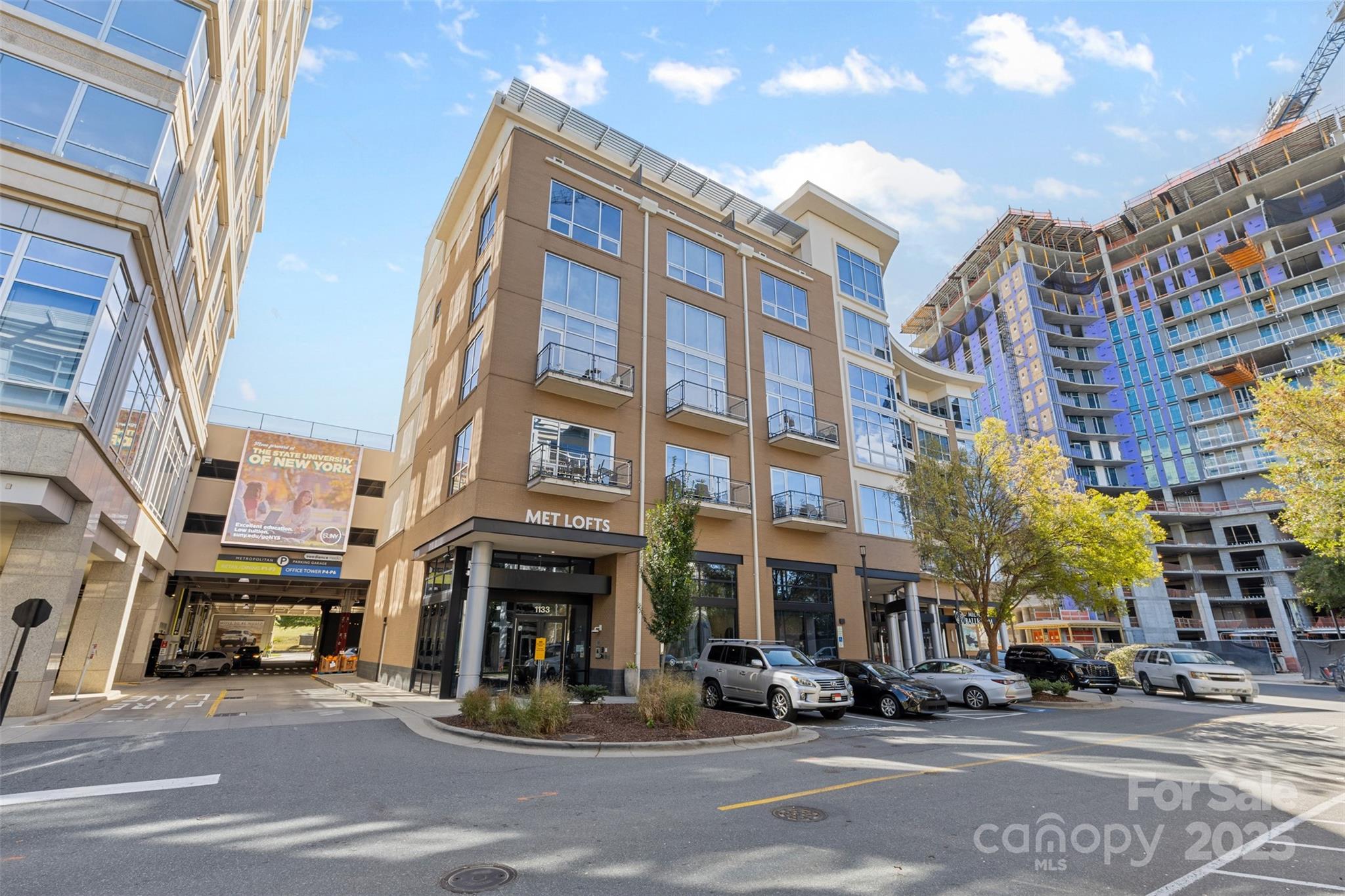 Welcome to this stunning 2 floors, 2-bedroom, 2.5-bath condominium on the 6th and 5th floor of the highly sought-after Metropolitan building—where style, comfort, and convenience converge in the heart of Uptown Charlotte.

Step inside to an open-concept main level featuring a sleek, fully equipped kitchen with stainless steel appliances, granite countertops, modern cabinetry, and a center island perfect for entertaining or casual dining. The spacious living area is anchored by an electric fireplace and opens to a private terrace, offering remarkable city and park views that create the perfect backdrop for your morning coffee or evening unwind.

Downstairs, discover two private bedrooms, each with its own ensuite bathroom and generous closet space. The primary suite also includes a dedicated workspace, ideal for remote professionals or students.

Enjoy a lifestyle of ease with secured parking, controlled building access, and exclusive community amenities including a fitness center, outdoor pool, and access to premier shopping, fine dining, and entertainment—all just steps away. Including Trader Joe's on the first floor.

Whether you're looking for a chic urban retreat or your first home in the city, 1133 Metropolitan Avenue offers the perfect blend of luxury, location, and lifestyle.
