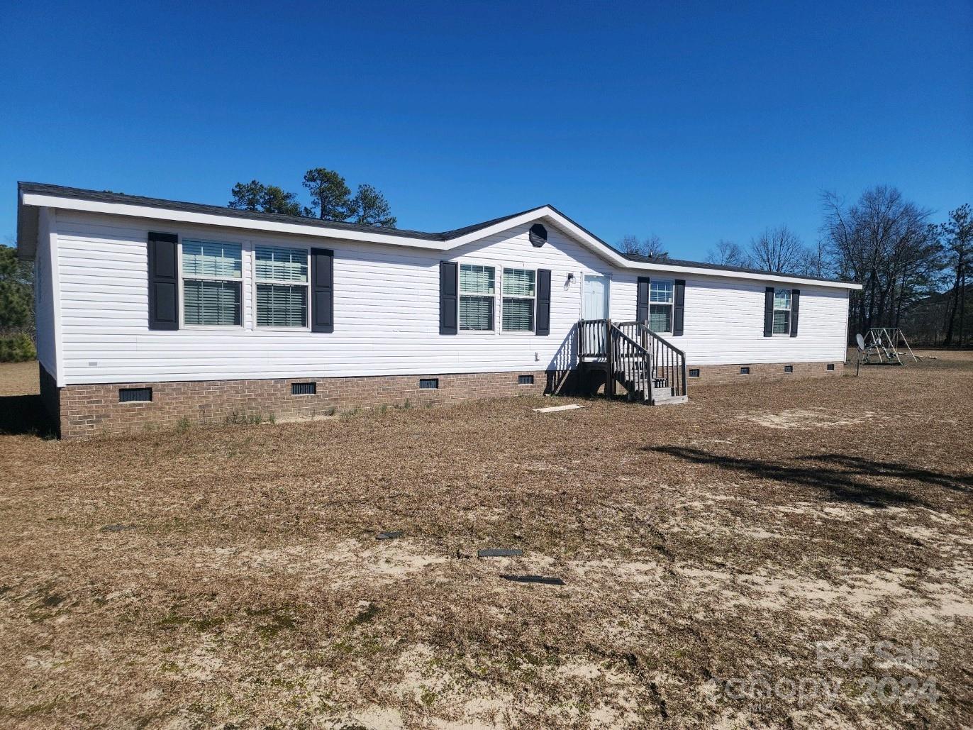 Don't miss this spacious DW manufactured home located on a 1.58 acre lot, within walking distance of Central High School!  It features open concept living room, kitchen/dining area.  The split bedroom plan offers privacy to the large primary bedroom/bathroom with soaking tub, double vanity and shower.  There is a flex space/den adjacent to the dining area, that leads to the three other bedrooms and full bathroom.  SELLER WILL CONTRIBUTE UP TO $5,000 TOWARDS BUYERS CLOSING COSTS.
